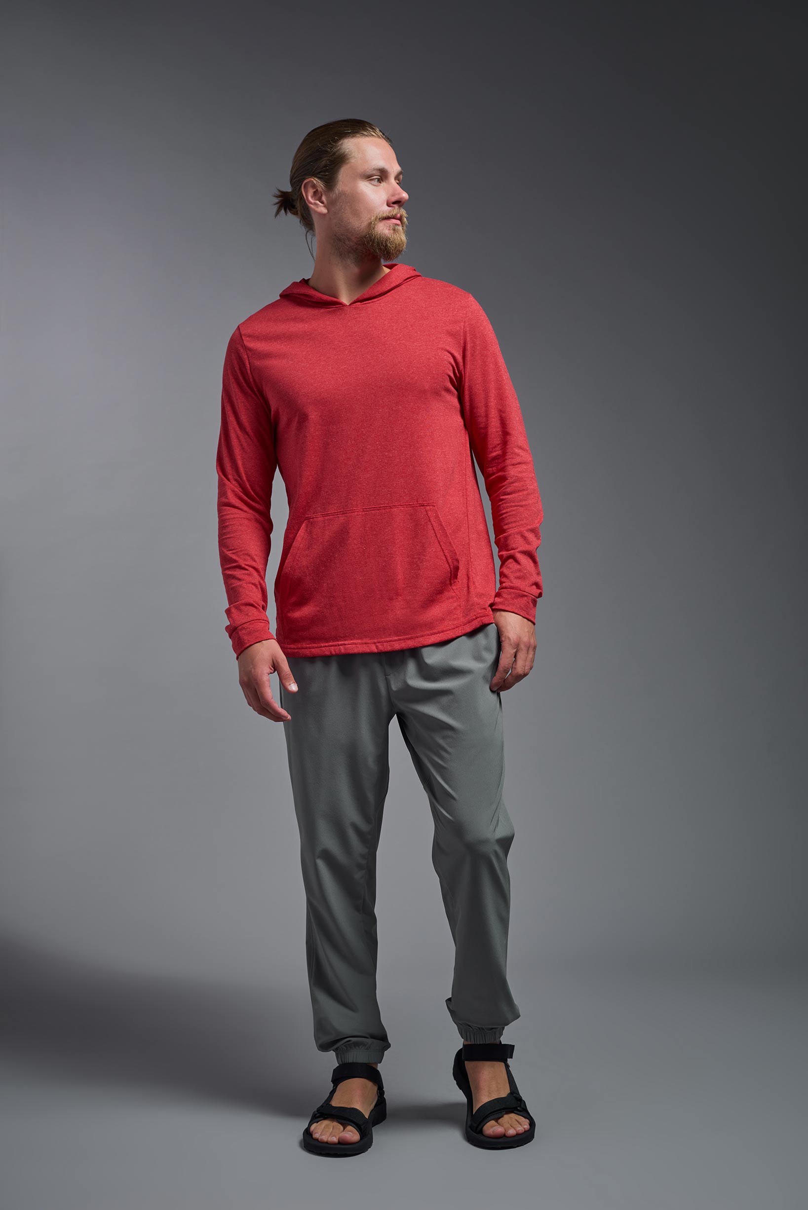 A male model wearing the men's Heather Hoodie Shirt in the color dark heather red, made out of 88% polyester and 22% treated cotton, showing the relaxed fit from a front view. This hoodie shirt is comfortable and made in the USA. #color_dark-heather-red