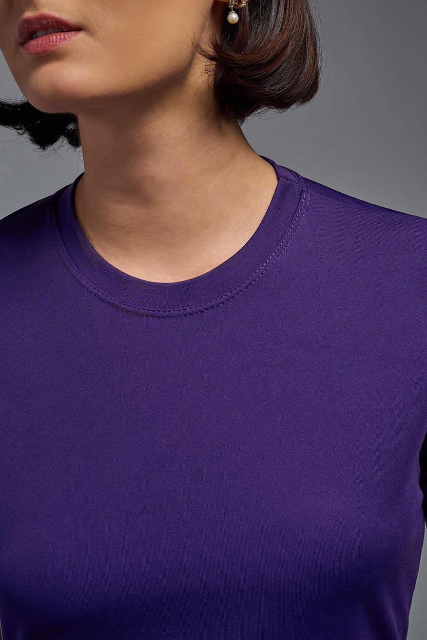 A female model wearing the women's DriMax Crewneck Expert Tee in the color dark purple, made out of 100% polyester, showing the relaxed fit from a close-up collar view. This shirt is quick-drying, moisture-wicking, offers up to 30 upf protection and is made in the USA. #deep-purple