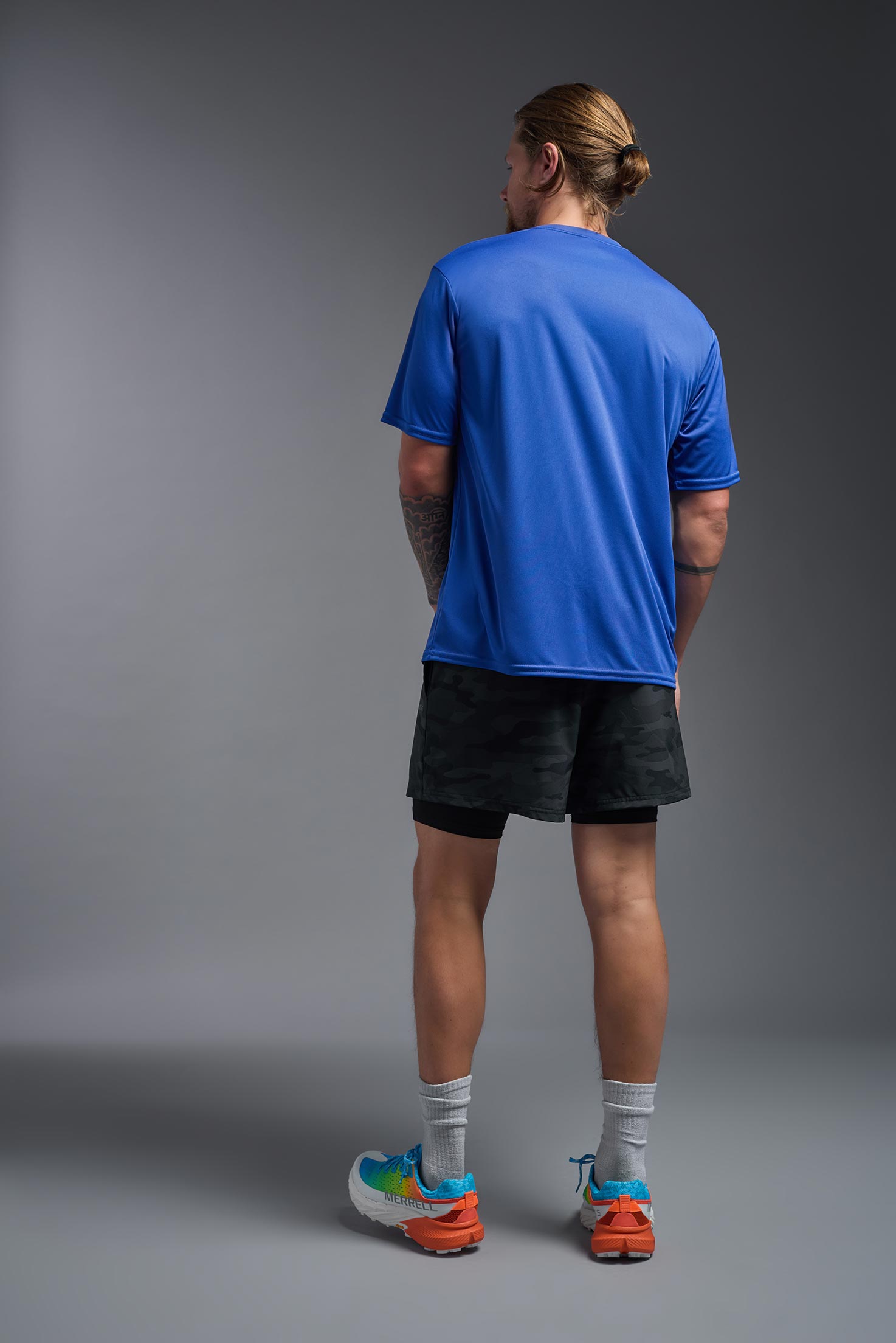 A male model wearing the men's DriMax Expert Tee in royal blue, made out of 100% polyester, showing the relaxed fit from a back view. #royal