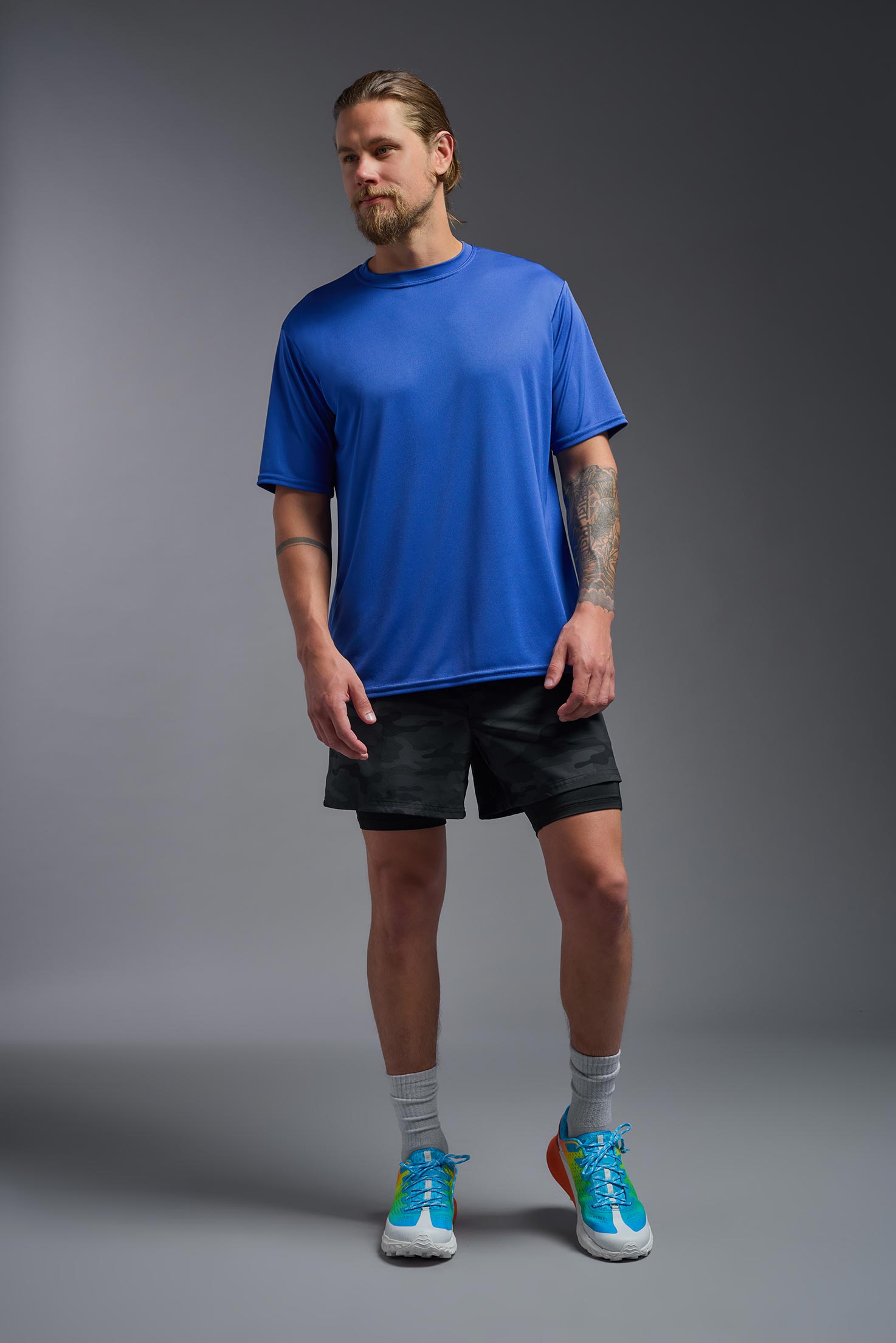 A male model wearing the men's DriMax Expert Tee in royal blue, made out of 100% polyester, showing the relaxed fit from a front view. #royal