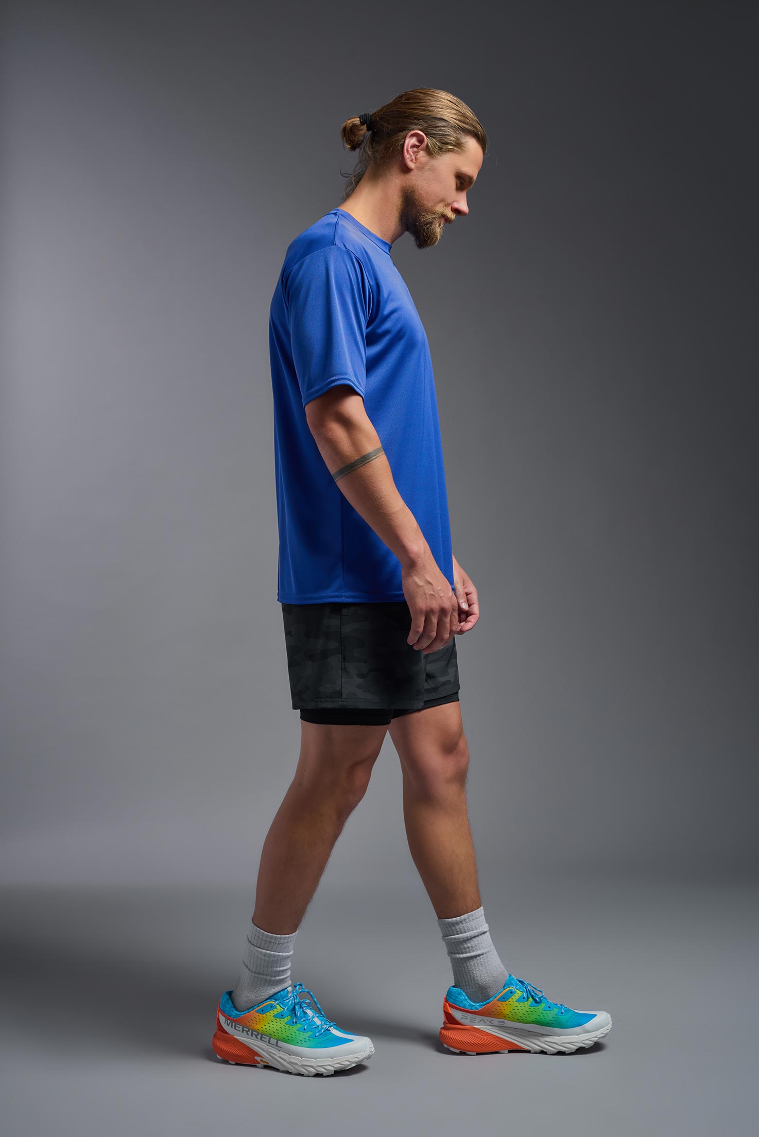 A male model wearing the men's DriMax Expert Tee in royal blue, made out of 100% polyester, showing the relaxed fit from a side view. #royal