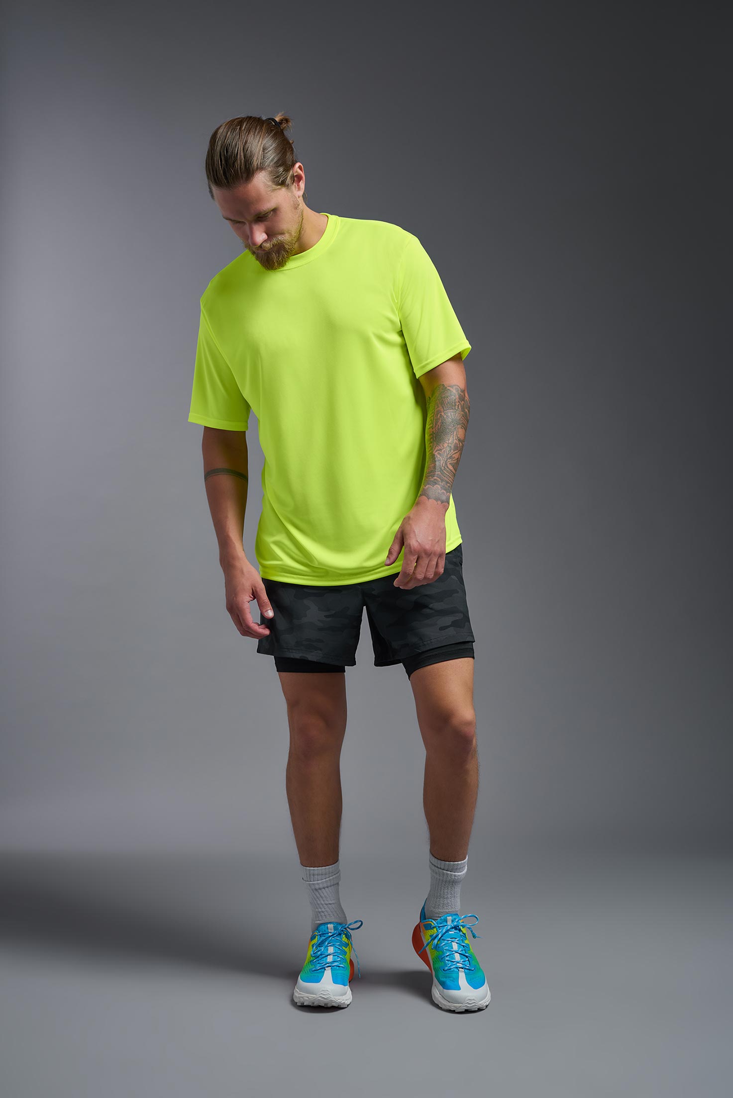 A male model wearing the men's DriMax Expert Tee in safety yellow, made out of 100% polyester, showing the relaxed fit from a front view. #safety-yellow