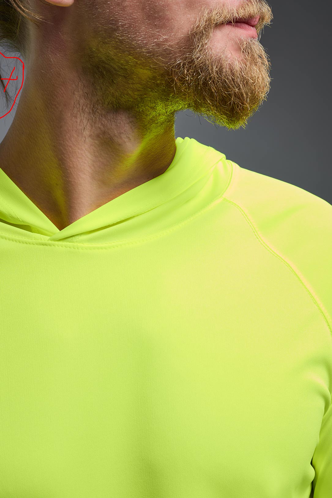 A male model wearing the men's DriMax Lightweight Hoodie in safety yellow, made out of 100% polyester, showing the relaxed fit from a close-up collar view. #safety-yellow
