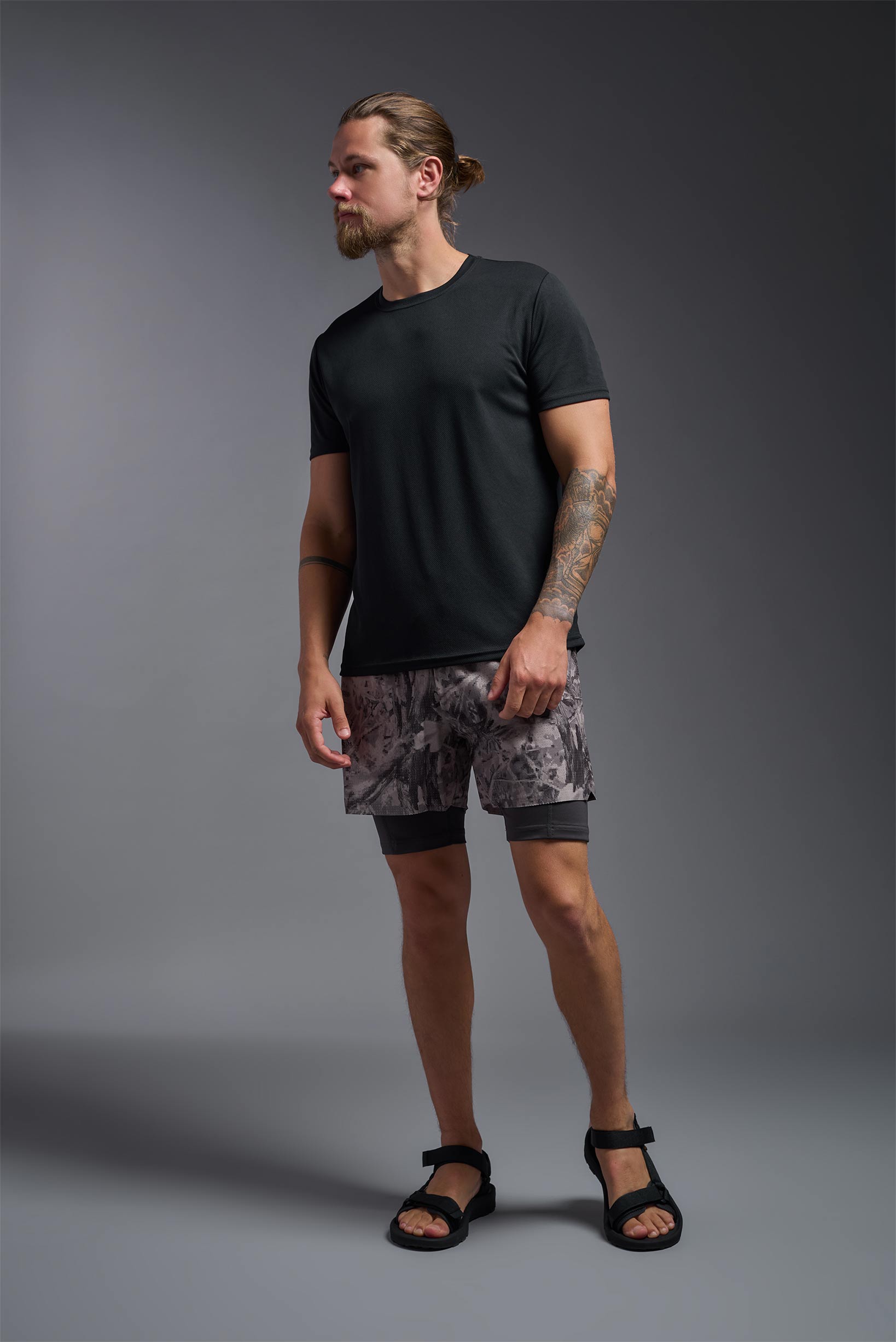 A male model wearing the men's Oxymesh Long Sleeve Tech Tee Imported Version in the color black, made out of 100% polyester, showing the relaxed fit from a front view. This shirt is breathable, quick-drying, moisture-wicking, and Imported for a better price on bulk apparel. #black