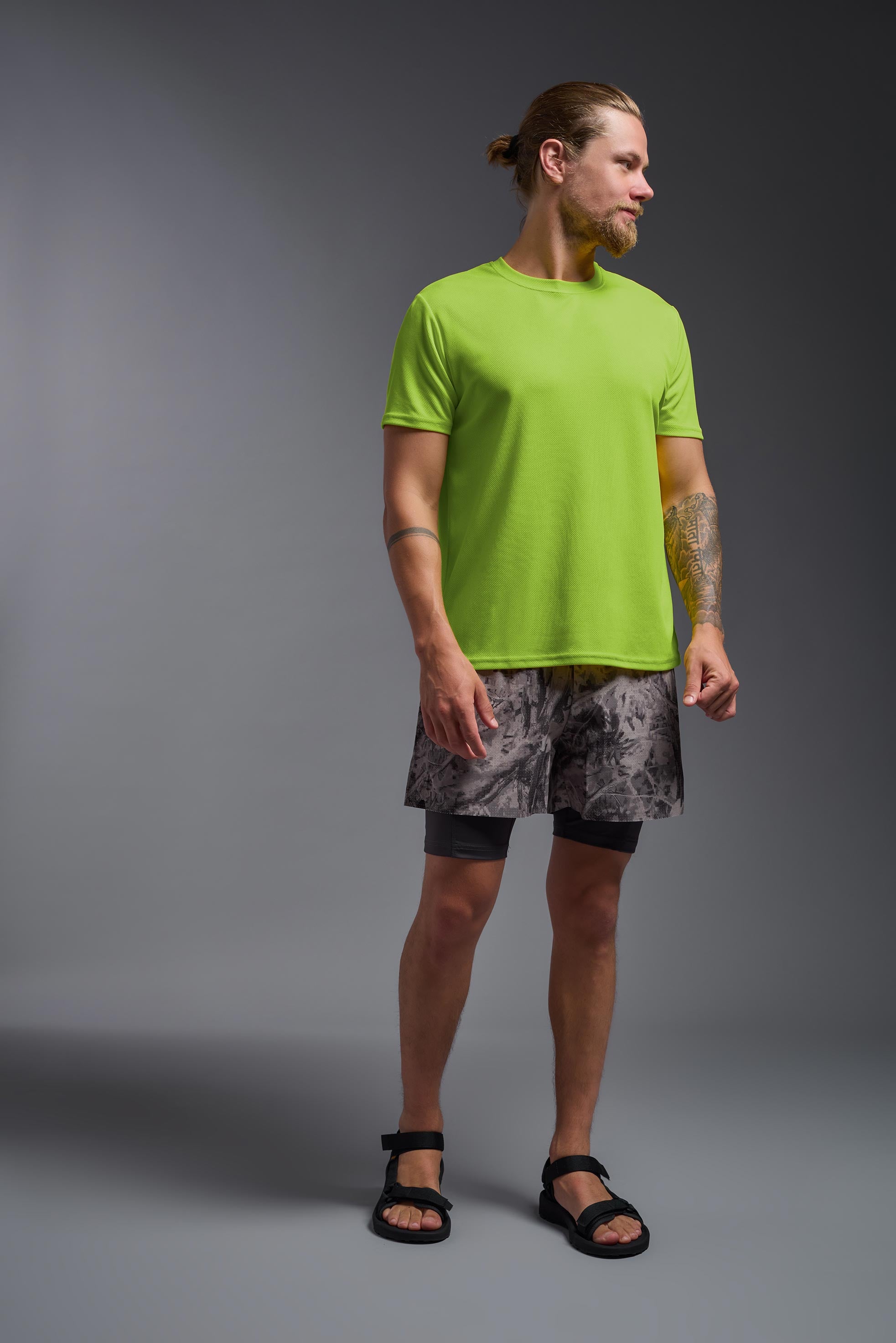 A male model wearing the men's Oxymesh Crewneck Tech Tee in the color key lime made out of 100% polyester, showing the relaxed fit from a front view. This shirt is breathable, wicks away moisture, quick-dries, and is made in the USA. #key-lime
