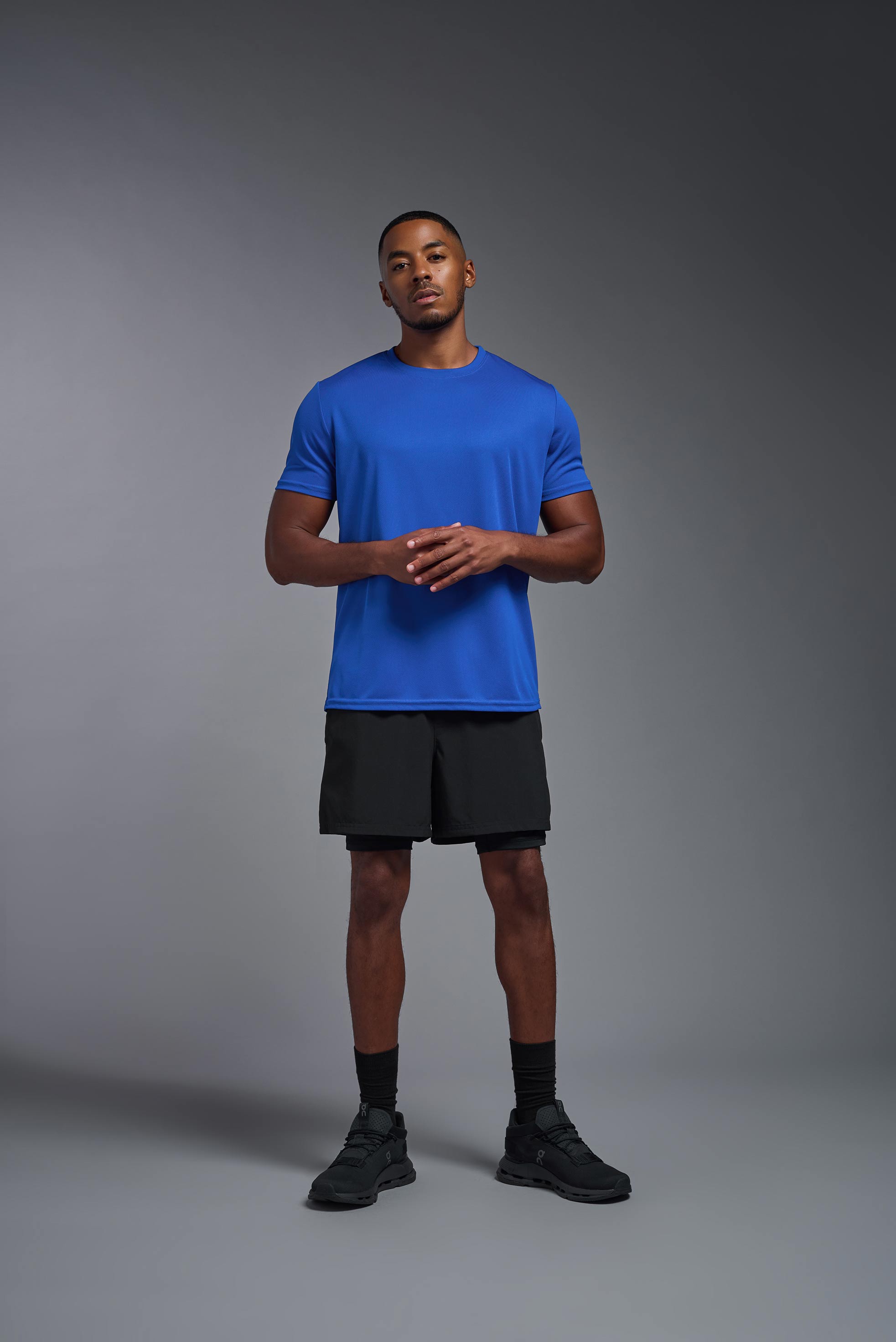 A male model wearing the men's Oxymesh Crewneck Tech Tee in the color royal blue made out of 100% polyester, showing the relaxed fit from a front view. This shirt is breathable, wicks away moisture, quick-dries, and is made in the USA. #royal-blue
