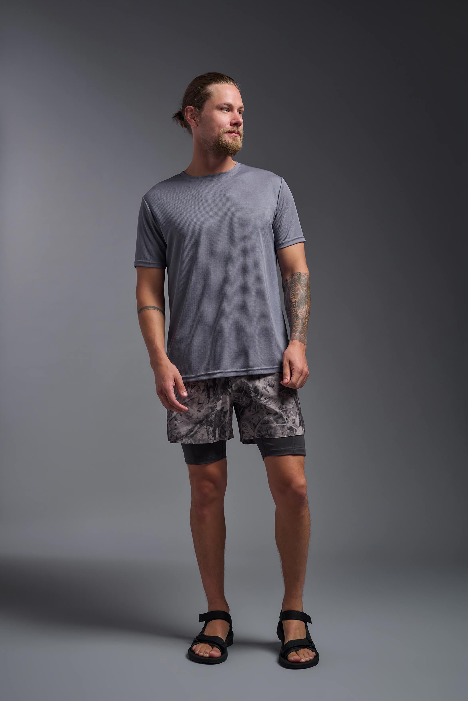 A male model wearing the men's Oxymesh Crewneck Tech Tee in the color steel gray made out of 100% polyester, showing the relaxed fit from a front view. This shirt is breathable, wicks away moisture, quick-dries, and is made in the USA. #steel-gray