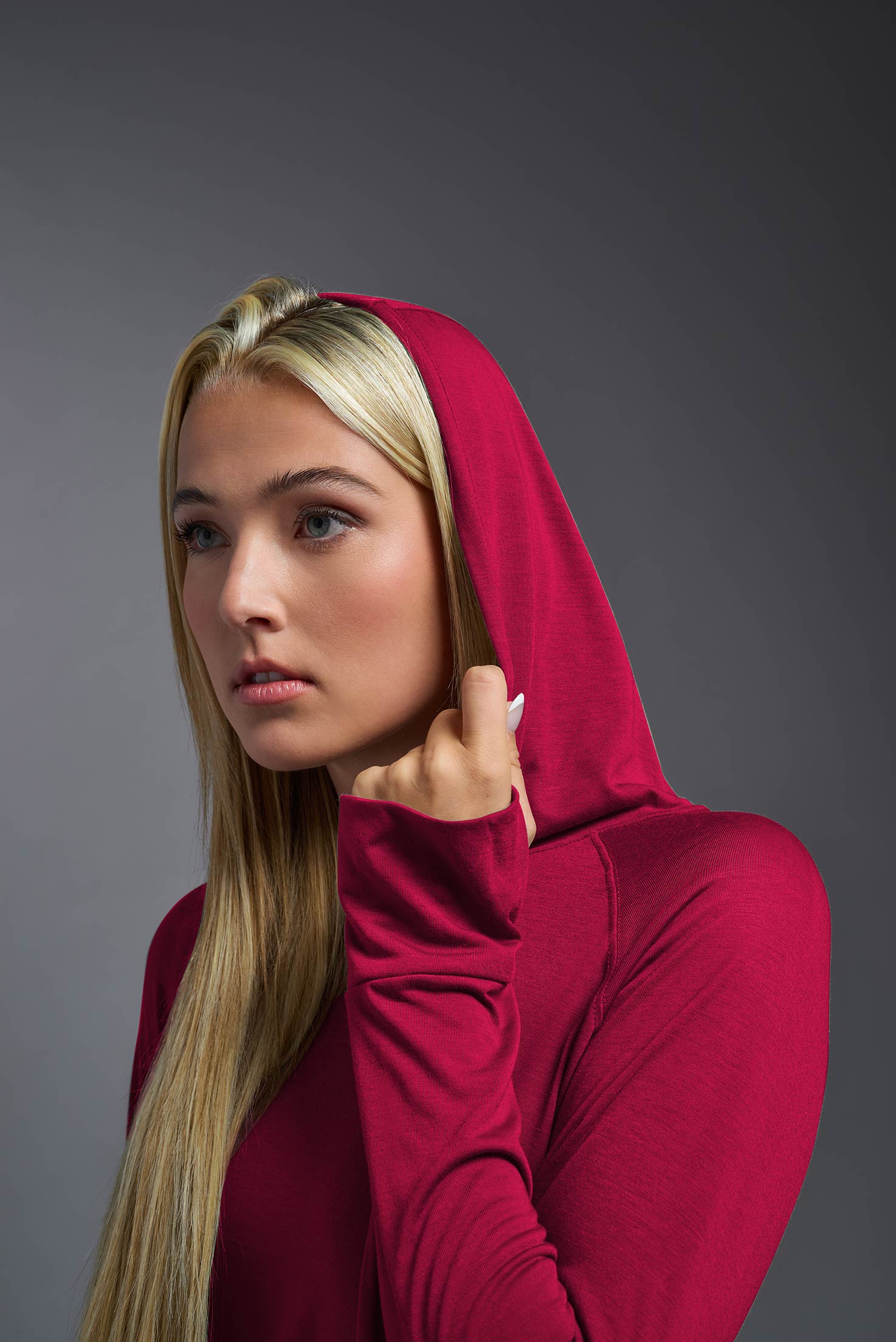 scarlet, made out of 100% filament polyester, showing the hood up from a closeup front view. This long sleeve hoodie shirt is breathable, quick-drying, moisture-wicking, and made in the USA. #scarlet