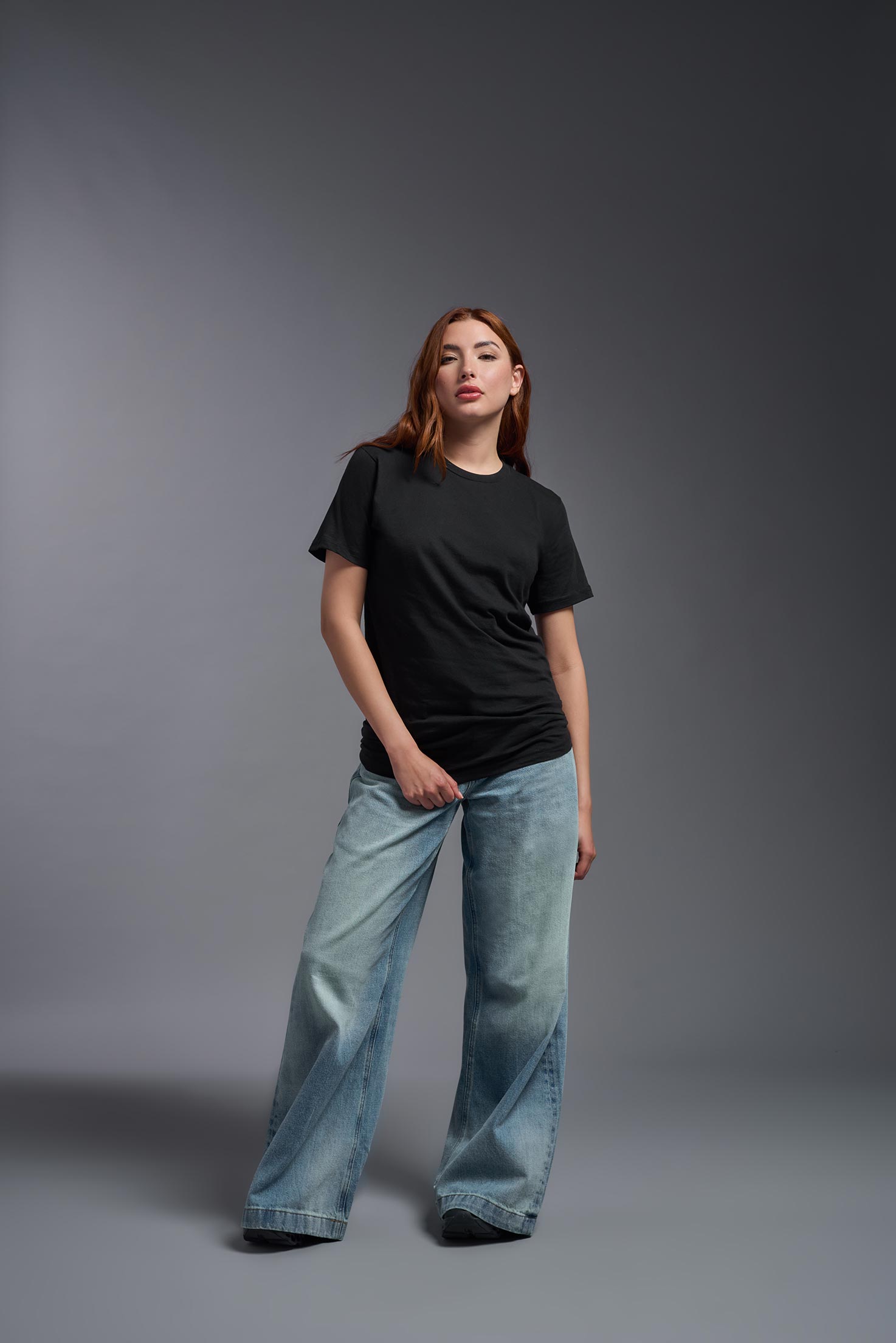 A male model wearing the unisex Americana Cotton Soft Tee in the color black, made from 100% combed ring-spun USA-grown cotton, showing the classic fit from a front view. This premium shirt is Made in the USA. #black