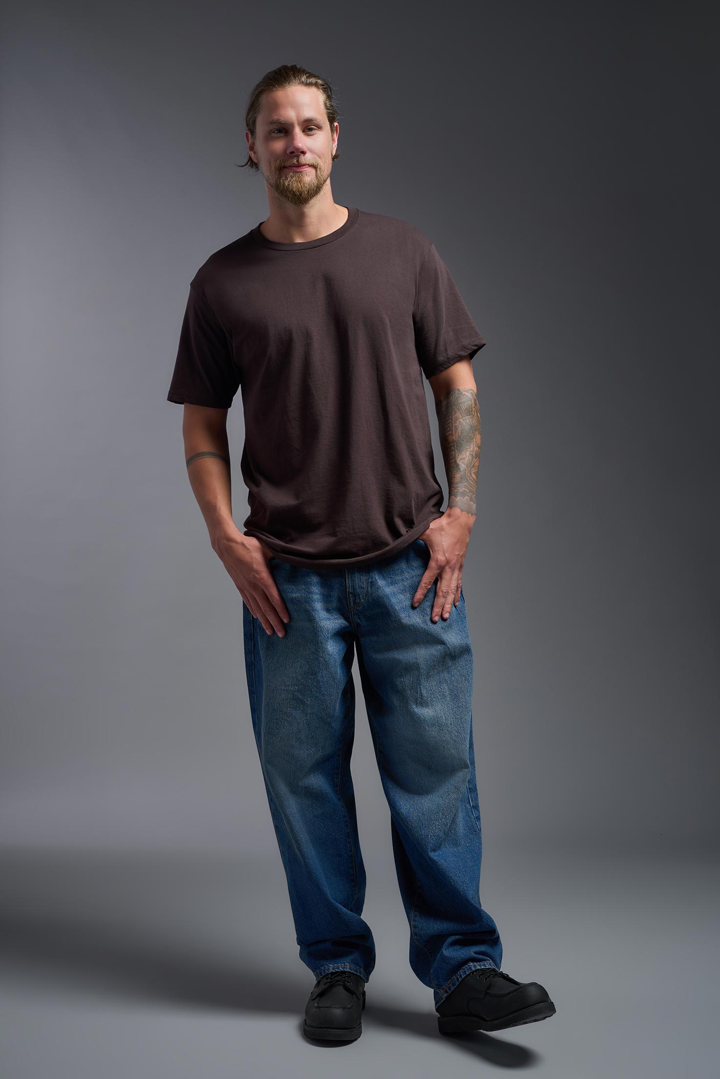 A male model wearing the unisex Americana Cotton Soft Tee in the color brown, made from 100% combed ring-spun USA-grown cotton, showing the classic fit from a  front view. This premium shirt is Made in the USA. #brown