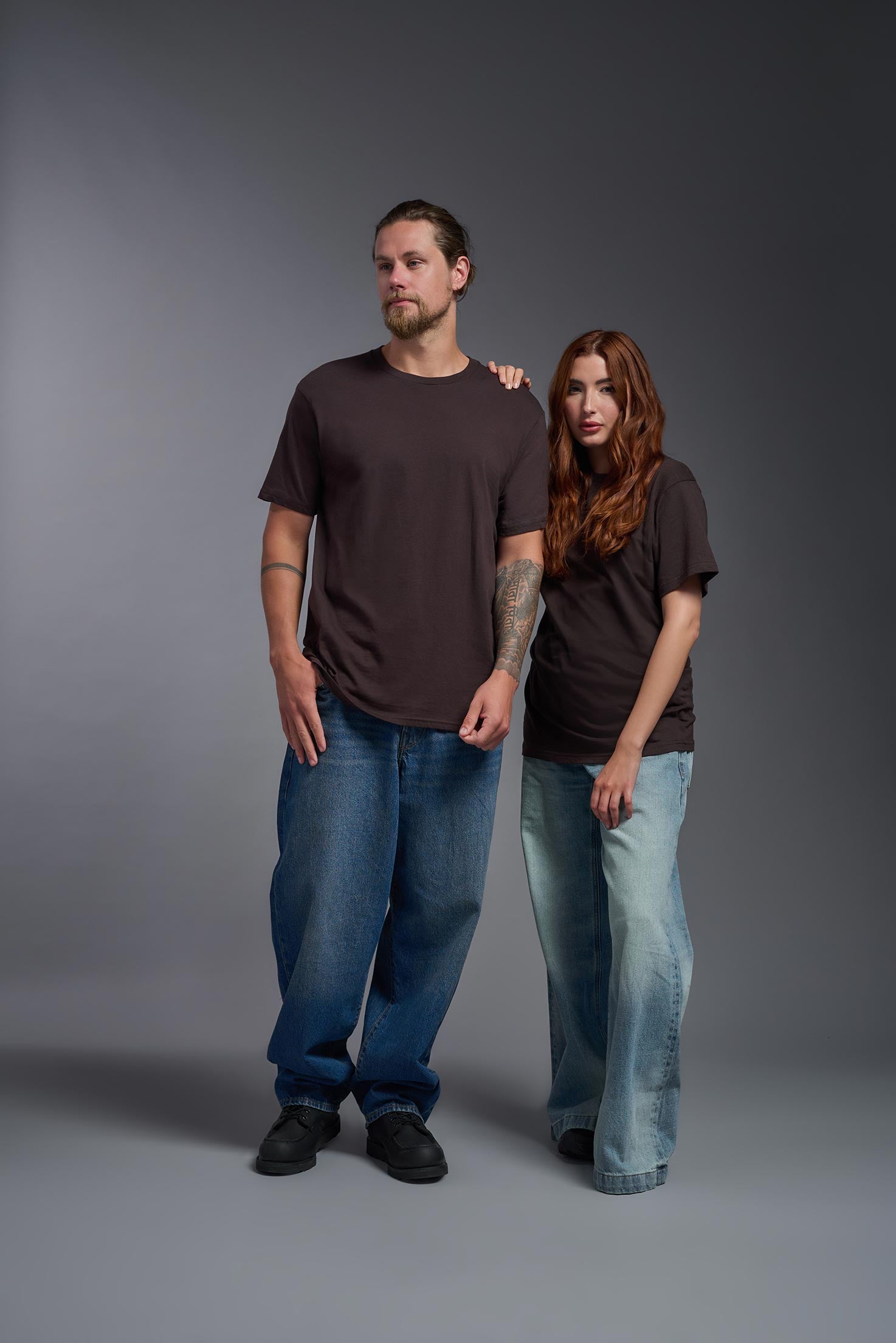 A male and female model wearing the unisex Americana Cotton Soft Tee in the color brown, made from 100% combed ring-spun USA-grown cotton, showing the classic fit from a front view. This premium shirt is Made in the USA. #brown