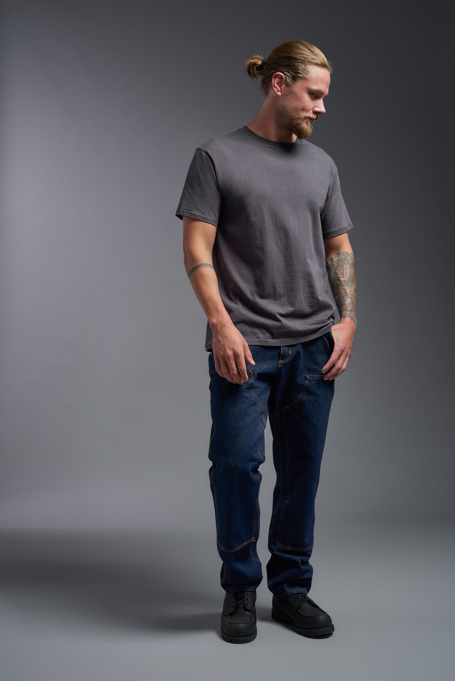 A male model wearing the unisex Americana Cotton Soft Tee in the color charcoal, made from 100% combed ring-spun USA-grown cotton, showing the classic fit from a front view. This premium shirt is Made in the USA. #charcoal