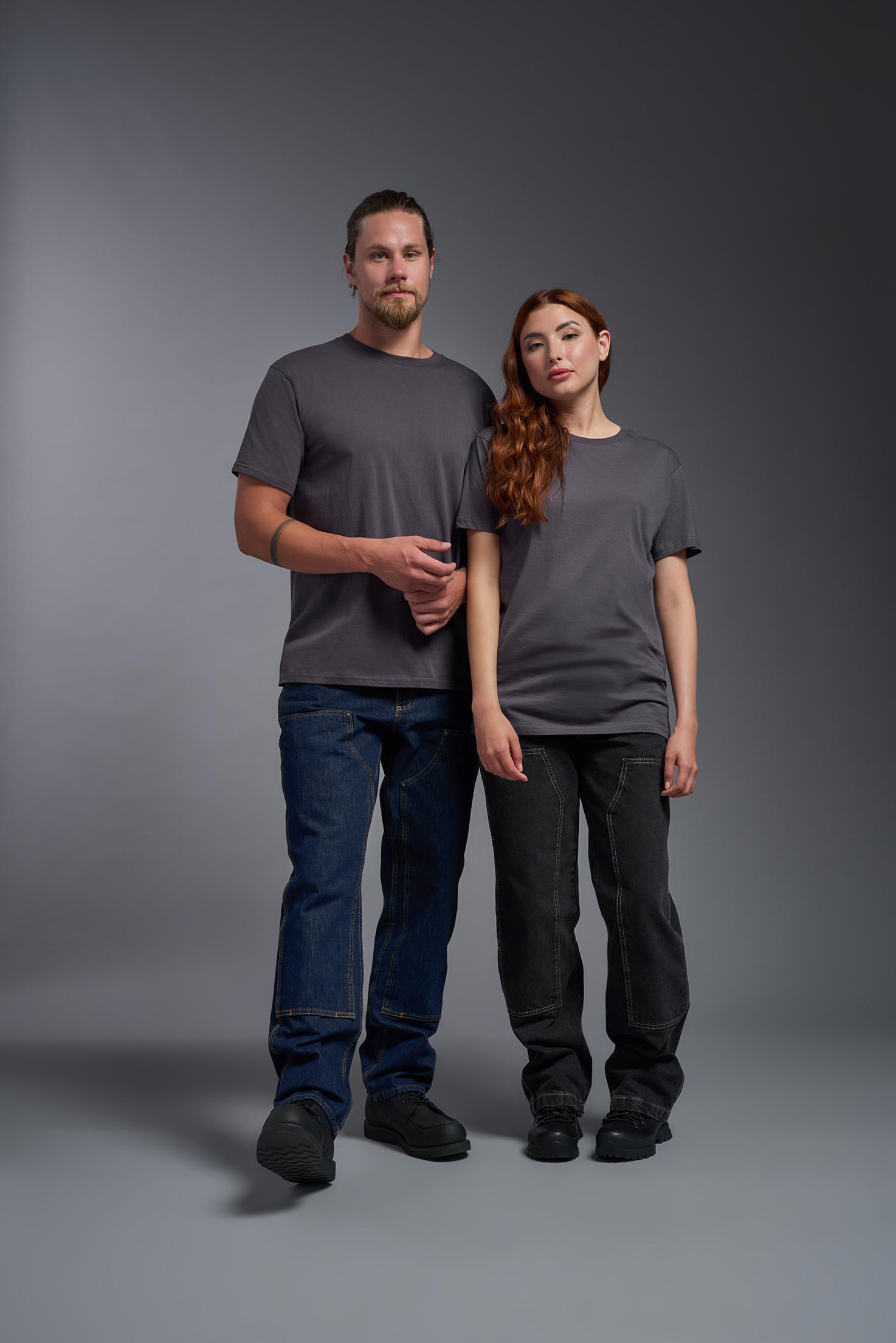 A male and female model wearing the unisex Americana Cotton Soft Tee in the color charcoal, made from 100% combed ring-spun USA-grown cotton, showing the classic fit from a front view. This premium shirt is Made in the USA. #charcoal