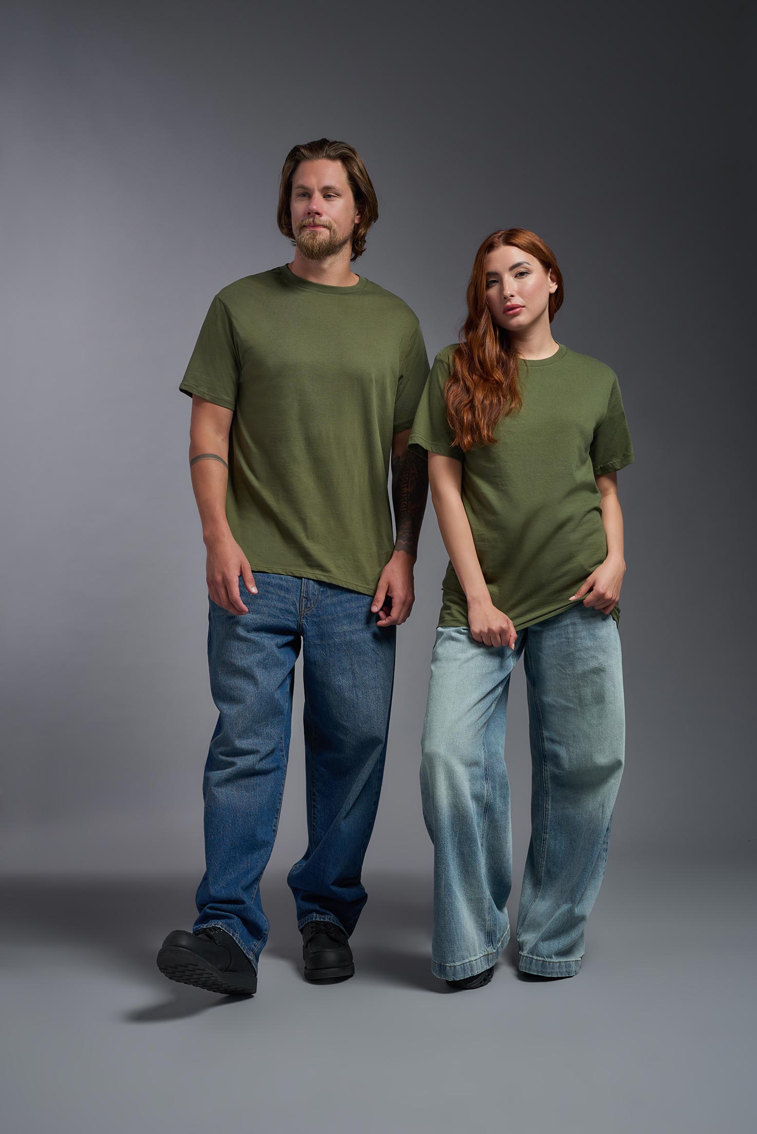 A male and female model wearing the unisex Americana Cotton Soft Tee in the color military green, made from 100% combed ring-spun USA-grown cotton, showing the classic fit from a front view. This premium shirt is Made in the USA. #military-green