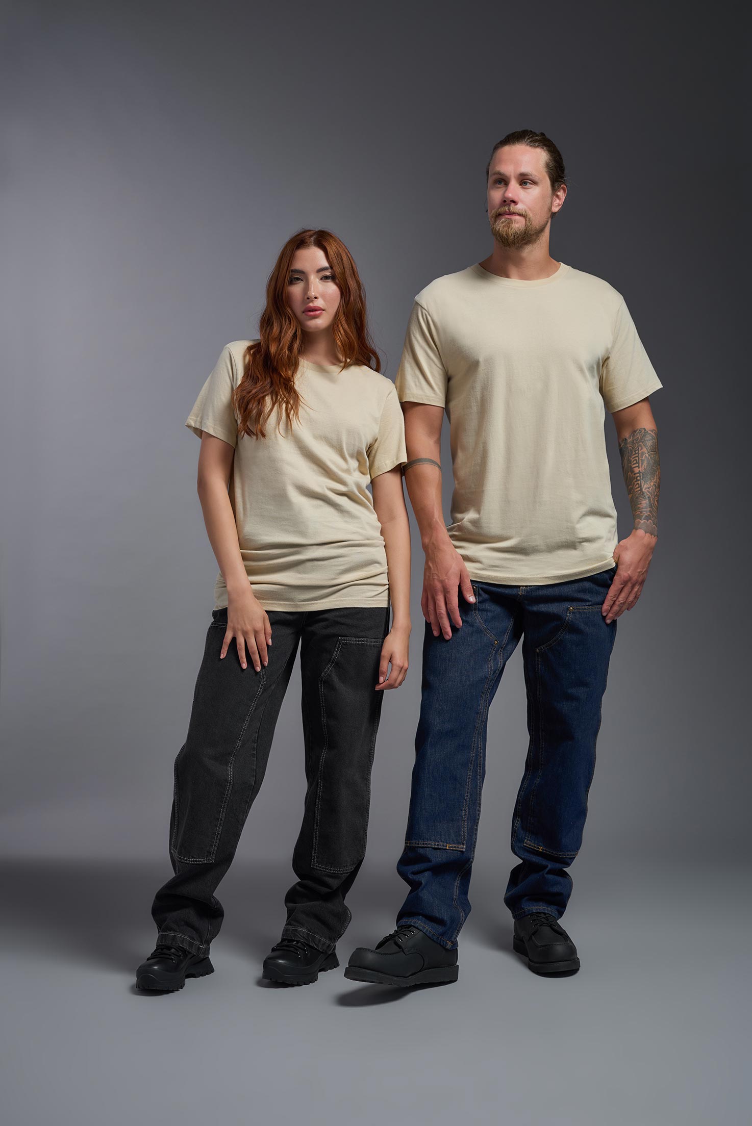 A male and female model wearing the unisex Americana Cotton Soft Tee in the color sand, made from 100% combed ring-spun USA-grown cotton, showing the classic fit from a front view. This premium shirt is Made in the USA. #sand