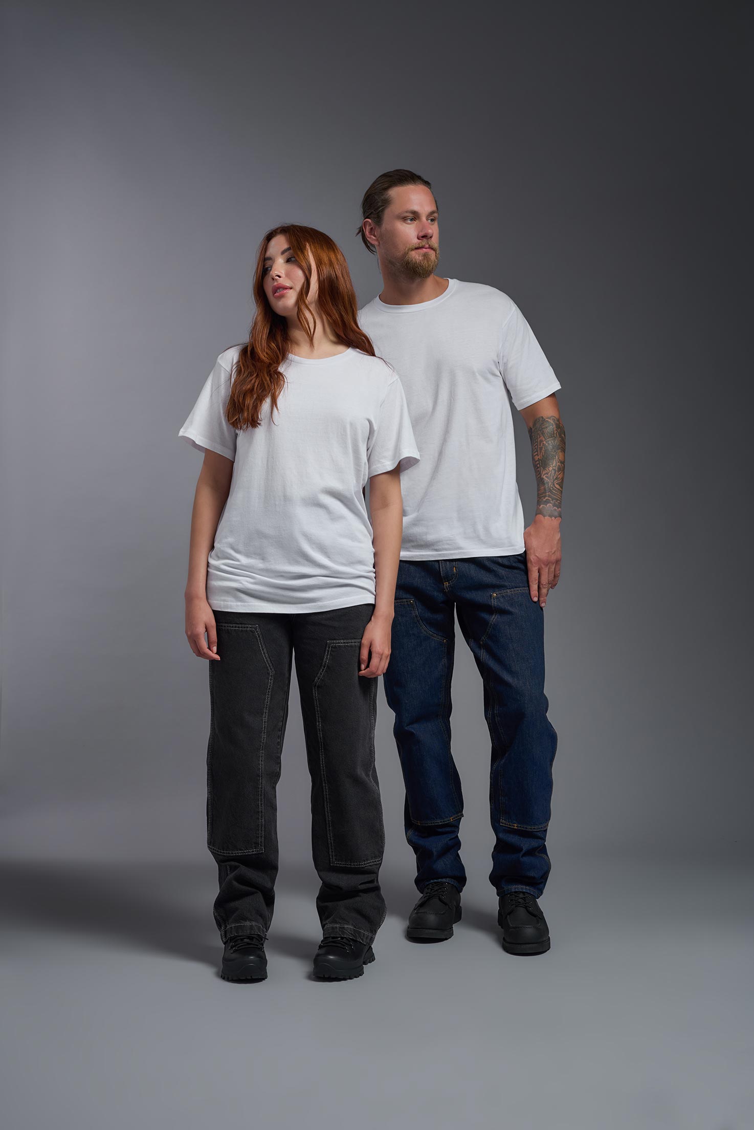 A male and female model wearing the unisex Americana Cotton Soft Tee in the color white, made from 100% combed ring-spun USA-grown cotton, showing the classic fit from a front view. This premium shirt is Made in the USA. #white