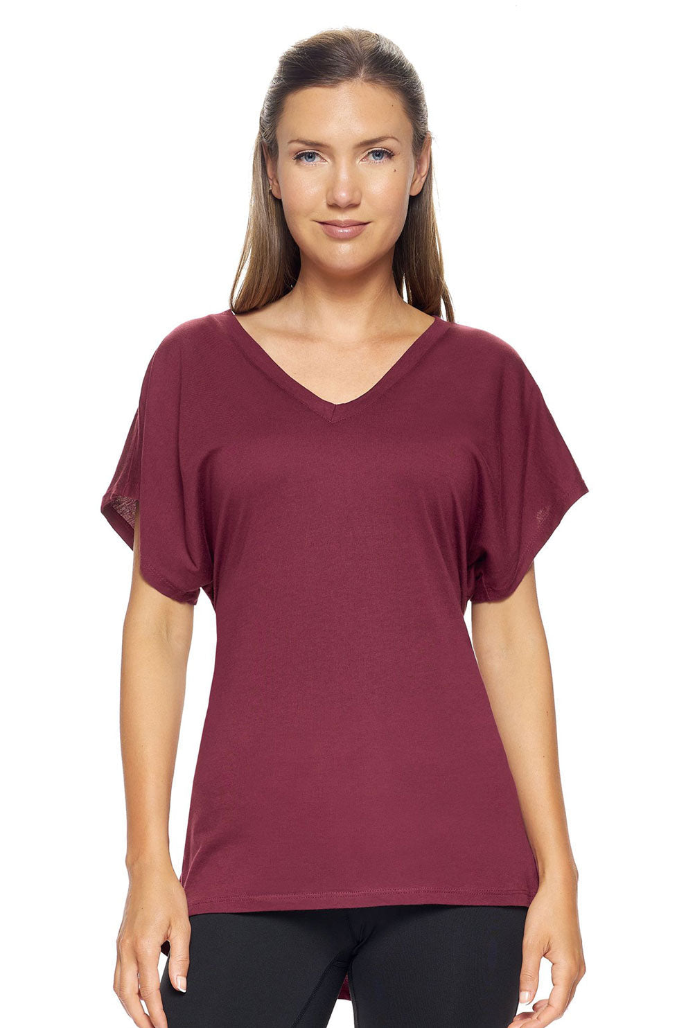 A female model with brown hair wearing the Women's MoCA V-Neck Cinch Tee in the color maroon, made from a luxurious blend of 50% LENZING Modal and 50% Combed Ring-Spun Cotton, showing the relaxed fit from a front view. This fashion-forward, more sustainable t-shirt is elevated, eco-friendly, made in the USA, and available for bulk purchase. #maroon