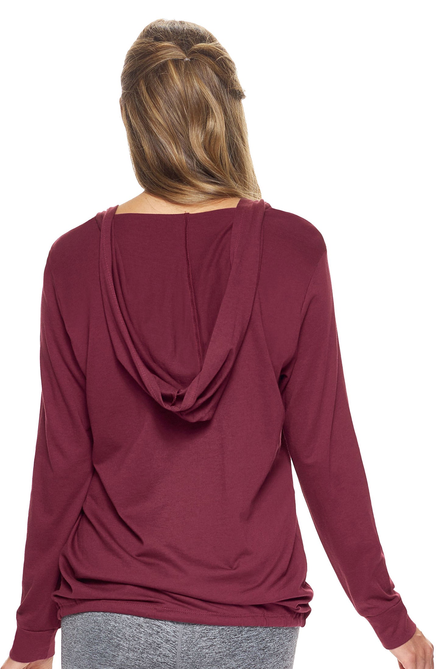 A female model with brown hair wearing the women's MoCA V-Neck Hoodie Shirt in the color maroon, made from a luxurious blend of 50% LENZING Modal and 50% Combed Ring-Spun Cotton, showing the relaxed fit from a back view. This fashion-forward, more sustainable t-shirt is elevated, eco-friendly, made in the USA, and available for bulk purchase. #maroon