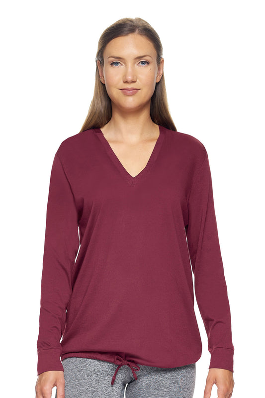 A female model with brown hair wearing the women's MoCA V-Neck Hoodie Shirt in the color maroon, made from a luxurious blend of 50% LENZING Modal and 50% Combed Ring-Spun Cotton, showing the relaxed fit from a front view. This fashion-forward, more sustainable t-shirt is elevated, eco-friendly, made in the USA, and available for bulk purchase. #maroon