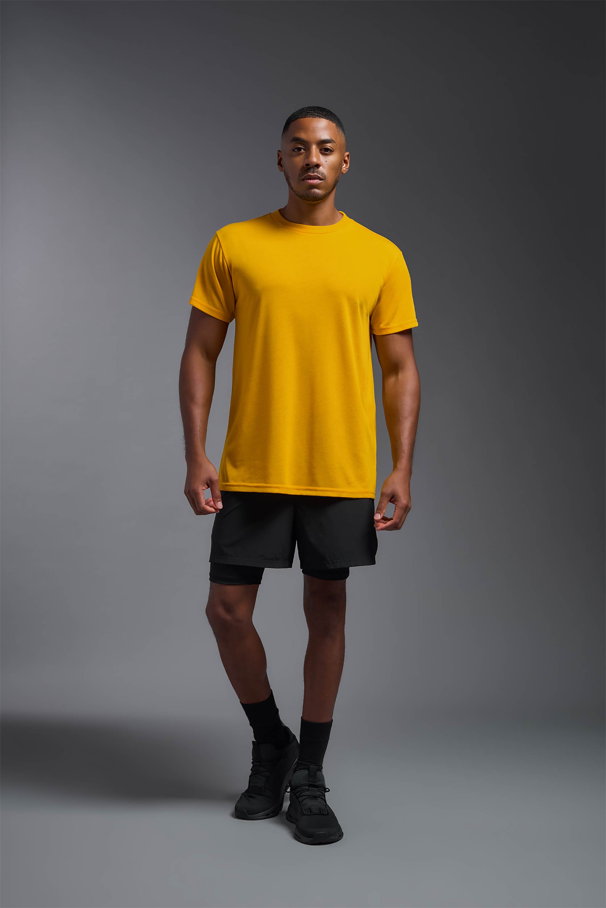 A male model wearing the men's DuroSoft Outdoor Tee in army yellow, made out of 100% filament polyester, showing the modern fit from a front view. This shirt quick-dries, wicks moisture and is made in the USA. #army-yellow