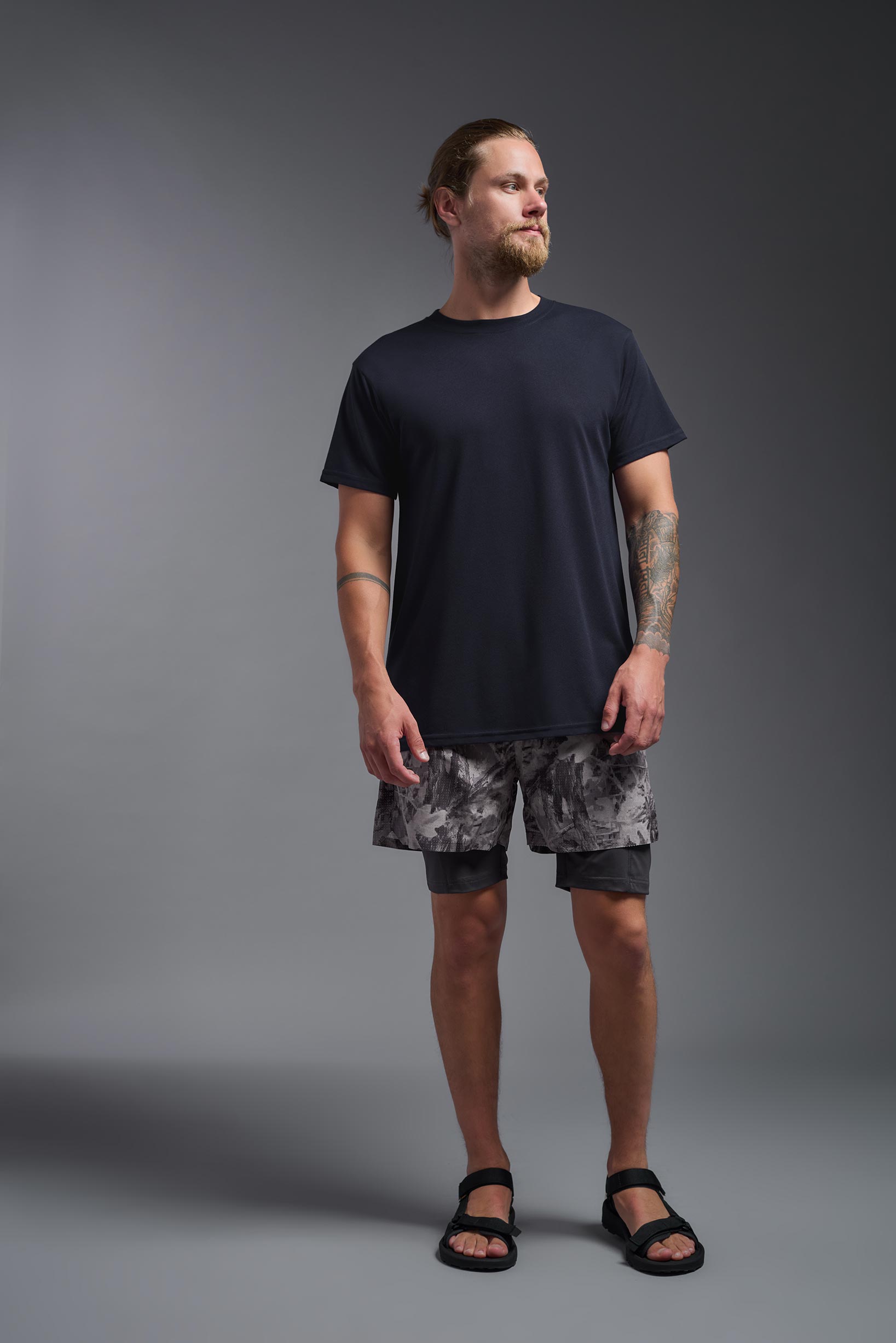 A male model wearing the men's DuroSoft Outdoor Tee in the color army blue, made out of 100% filament polyester, showing the modern fit from a front view. This shirt quick-dries, wicks moisture and is made in the USA. #army-blue