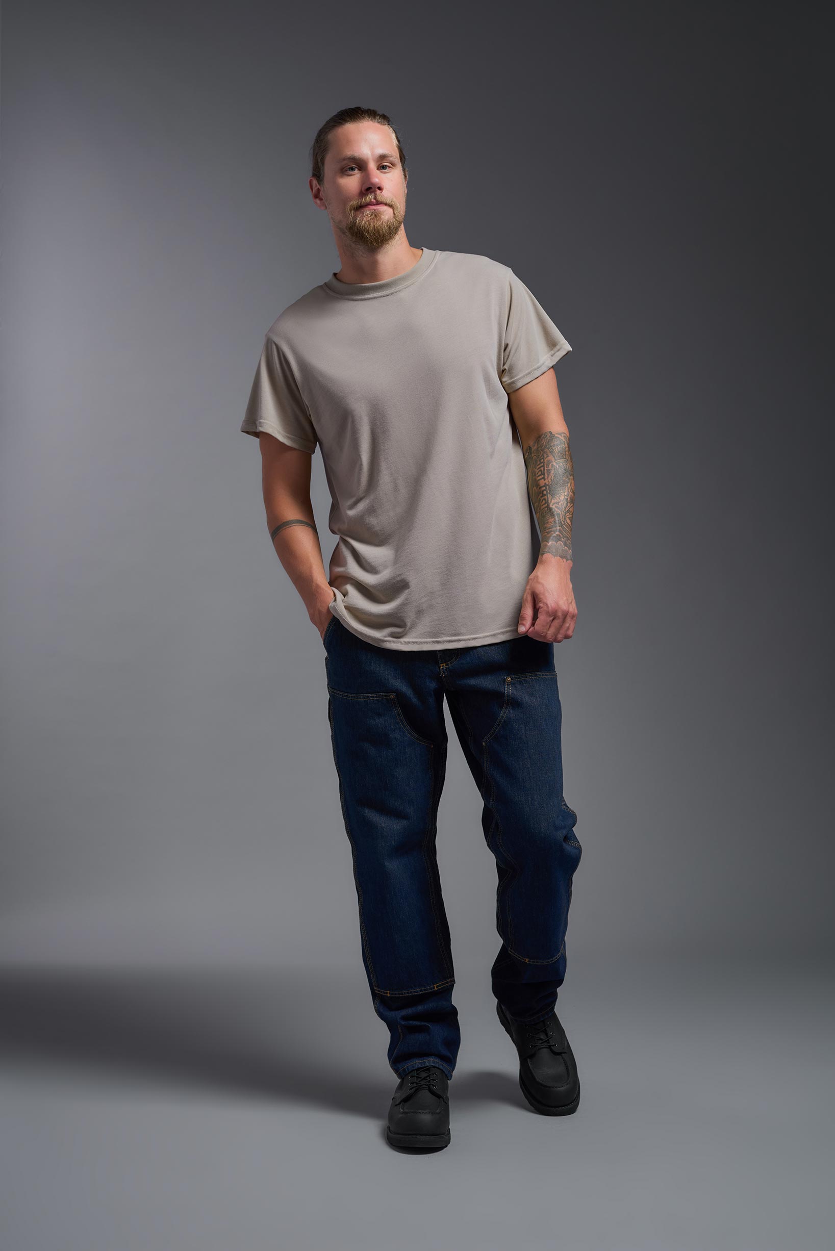 A male model wearing the men's DuroSoft Outdoor Tee in the color desert, made out of 100% filament polyester, showing the modern fit from a front view. This shirt quick-dries, wicks moisture and is made in the USA. #desert
