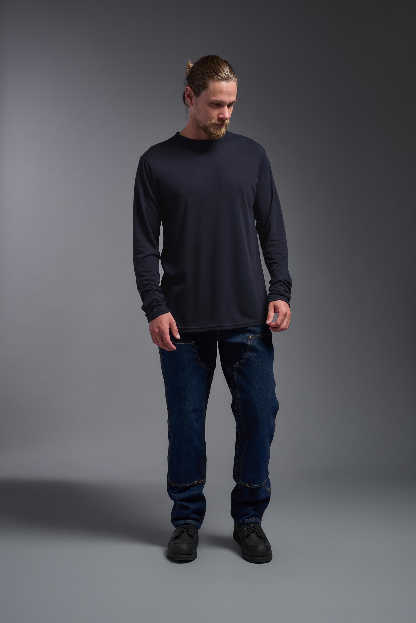 A male model wearing the men's DuroSoft Outdoor Long Sleeve in the color army blue, made out of 100% filament polyester, showing the modern fit from a front view. This shirt quick-dries, wicks moisture and is made in the USA. #army-blue