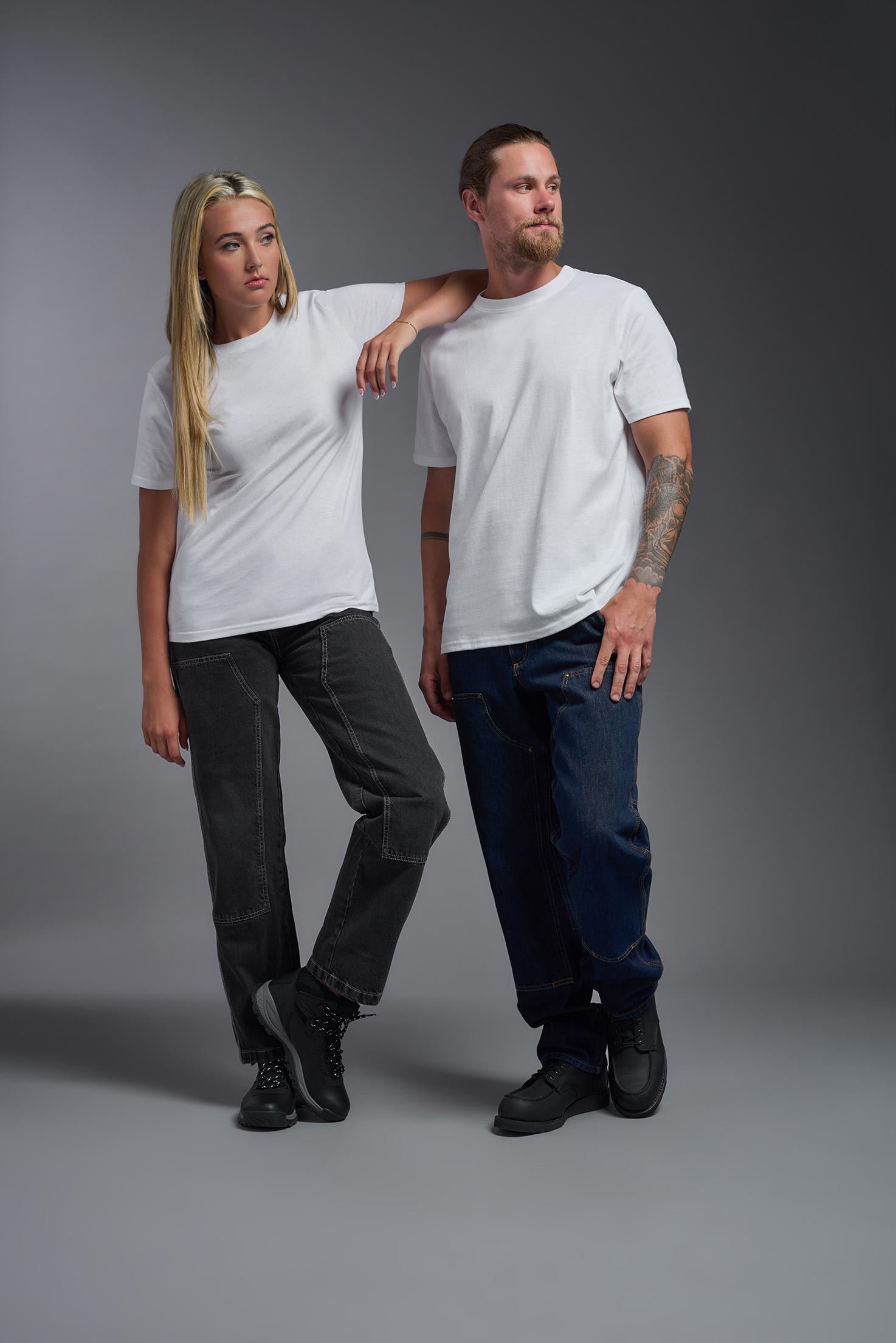 A male and female model wearing the unisex Imagen Short Sleeve Crewneck T-Shirt in the color white, made from 50% U.S. Grown Regenerative Cotton and 50% Recycled Polyester, showing the Relaxed Fit from a front view. This sustainable shirt is Made in the USA. #white