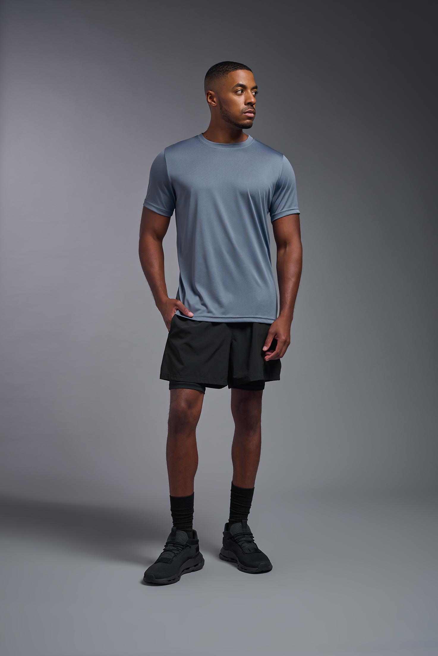 A male model wearing the men's EcoTek™ Recycled Performance Tee in the color tahoe, made out of 100% recycled polyester REPREVE®, showing the modern fit from a front view. This shirt features a mechanical stretch, quick-dries, wicks moisture and is made in the USA. #tahoe