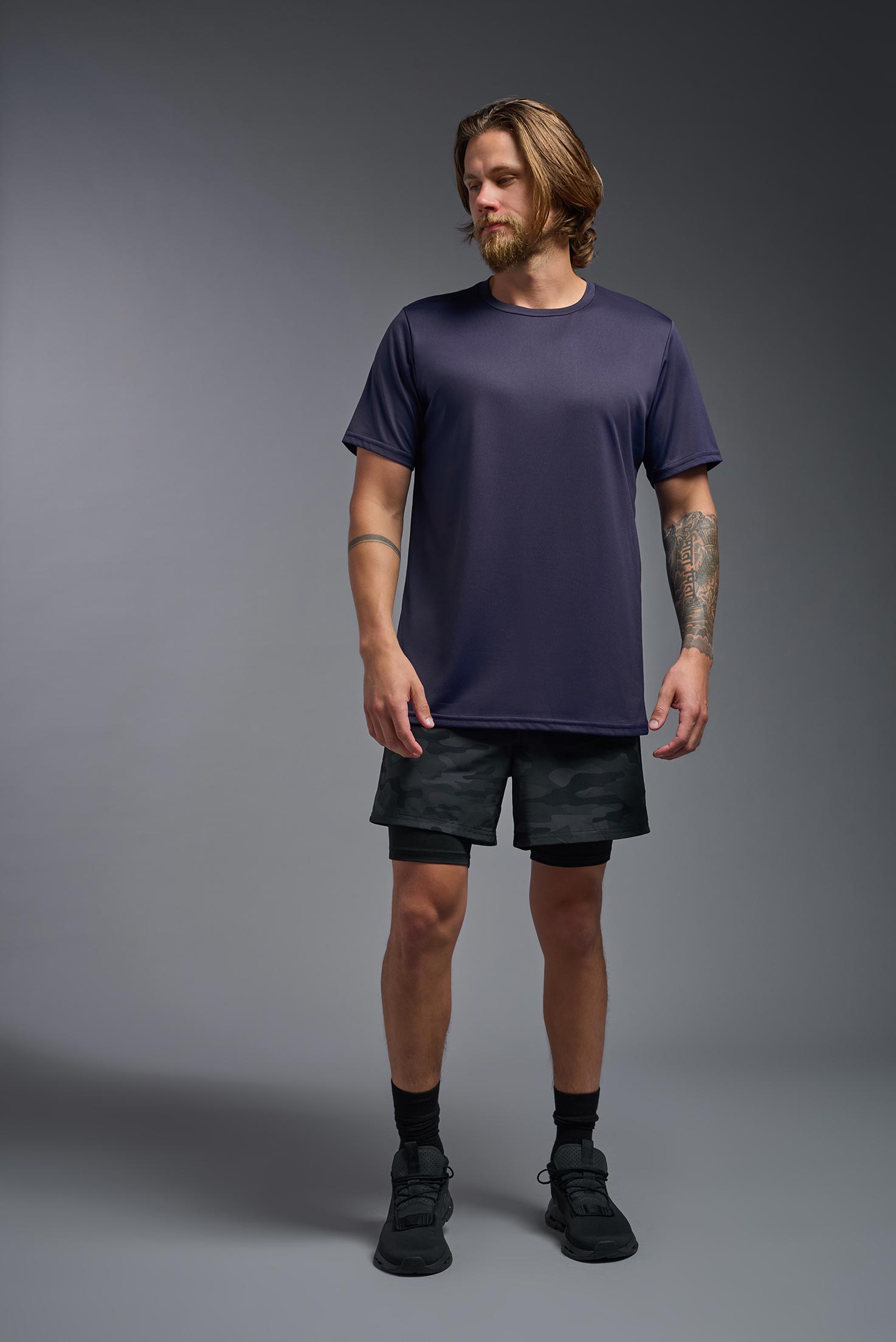 A male model wearing the men's EcoTek™ Recycled Performance Tee in the color twilight, made out of 100% recycled polyester REPREVE®, showing the modern fit from a front view. This shirt features a mechanical stretch, quick-dries, wicks moisture and is made in the USA. #twilight