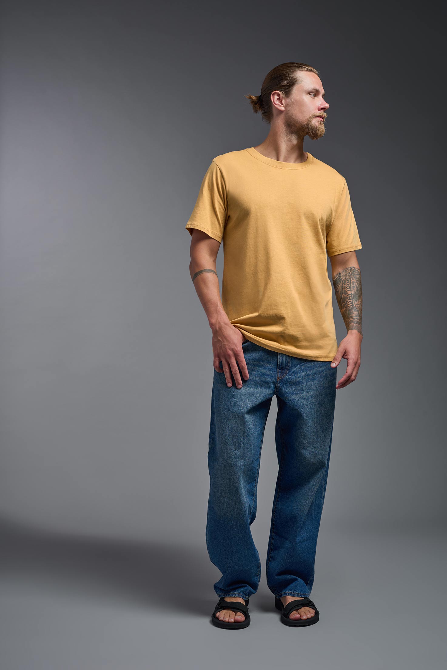 A male model wearing the unisex Organic Soft Cotton T-shirt in the color harvest, made in the USA from 100% GOTS certified organic cotton from a front view. This shirt is unisex, made in the USA, and perfect for bulk screen printing and decorating. #harvest