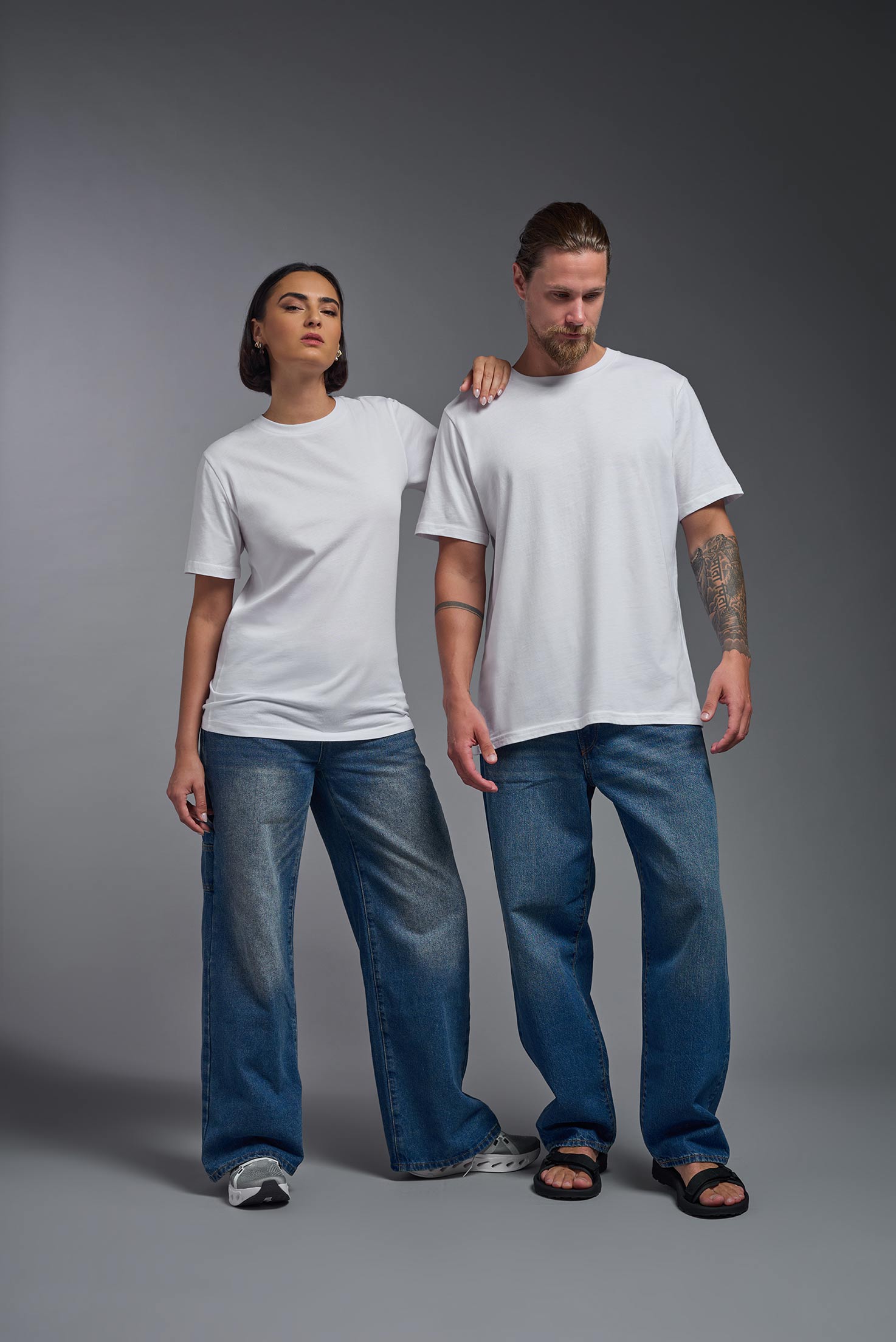 A male and female model wearing the unisex Organic Soft Cotton T-shirt in the color  white, made in the USA from 100% GOTS certified organic cotton from a front view. #white