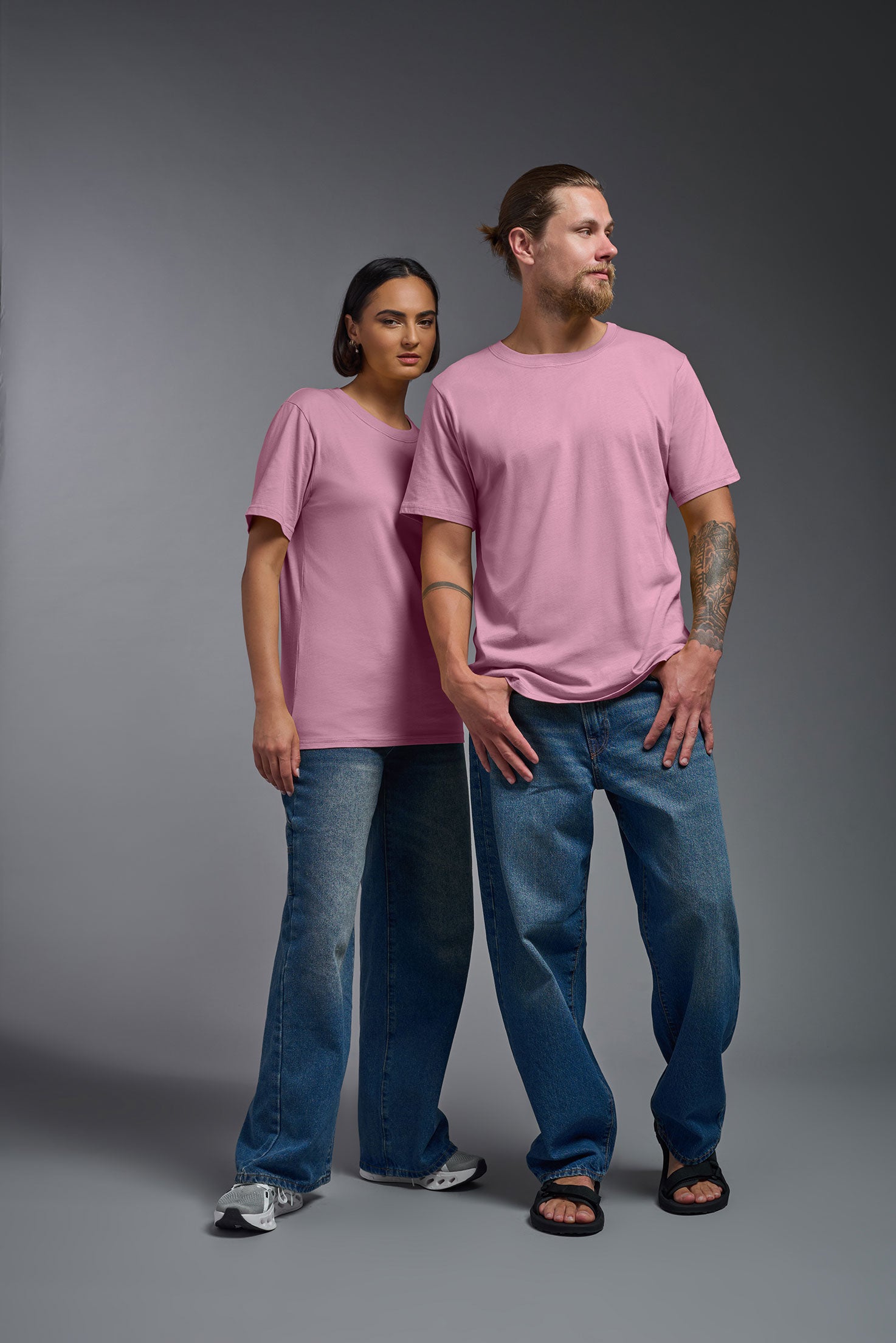 A female and male model wearing the unisex Organic Soft Cotton T-shirt in the color Himalayan salt pink, made in the USA from 100% GOTS certified organic cotton from a front view. This shirt is unisex, made in the USA, and perfect for bulk screen printing and decorating. #himalayan-salt