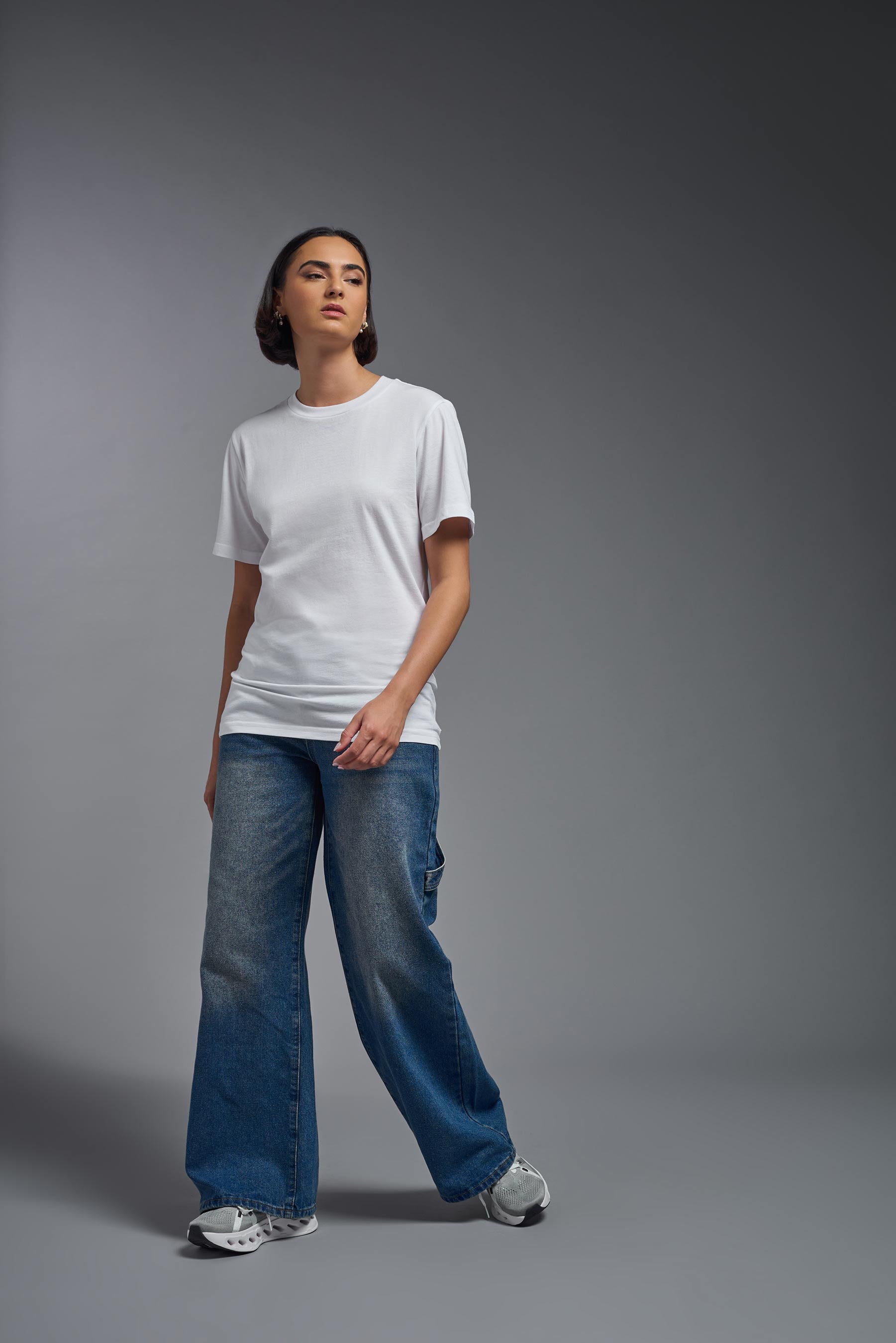 A female model wearing the unisex Organic Soft Cotton T-shirt in the color white, made in the USA from 100% GOTS certified organic cotton from front view. #white