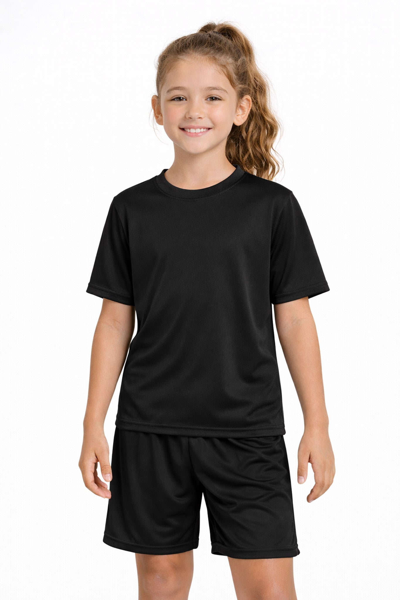 A youth model wearing the youth DriMax Crewneck Expert Tee in the color black, made out of 100% polyester, showing the relaxed fit from a front view. This shirt wicks sweat, quick-dries, and eliminates odors for up to 30 UV protection. Made in the USA. #black
