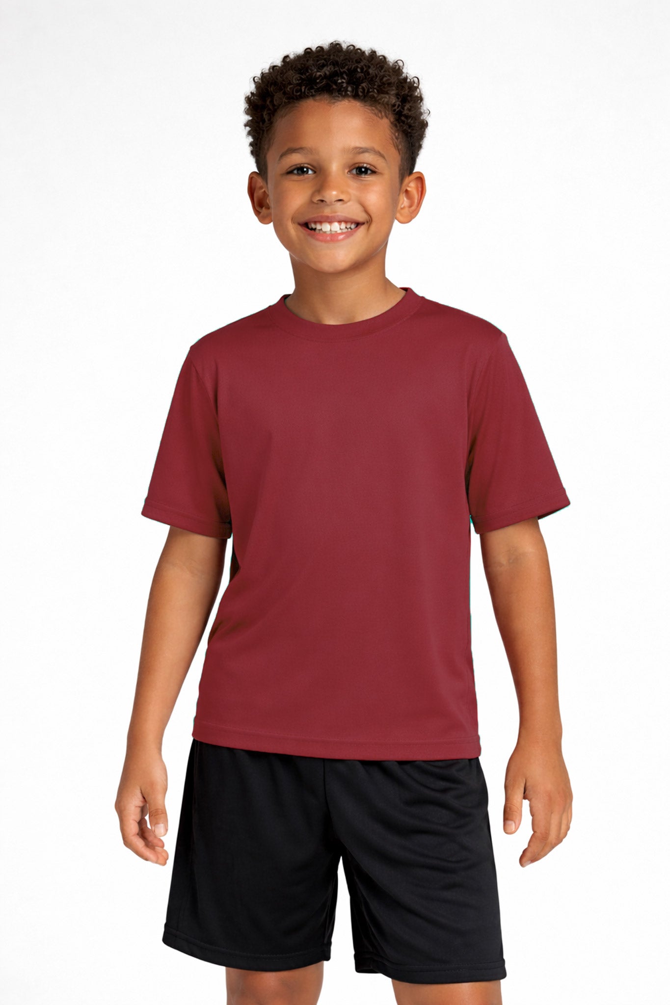 A youth model wearing the youth DriMax Crewneck Expert Tee in the color cardinal, made out of 100% polyester, showing the relaxed fit from a front view. This shirt wicks sweat, quick-dries, and eliminates odors for up to 30 UV protection. Made in the USA. #cardinal
