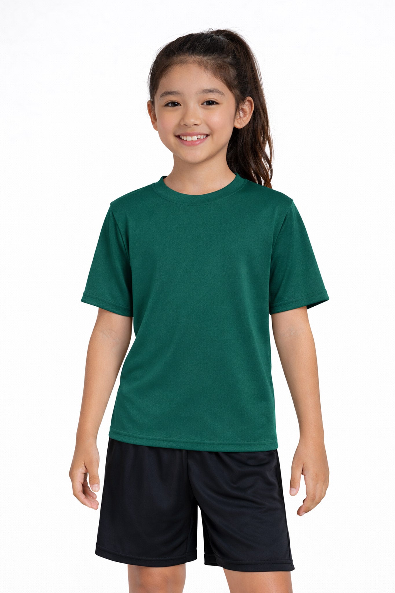 A youth model wearing the youth DriMax Crewneck Expert Tee in the color forest green, made out of 100% polyester, showing the relaxed fit from a front view. This shirt wicks sweat, quick-dries, and eliminates odors for up to 30 UV protection. Made in the USA. #forest