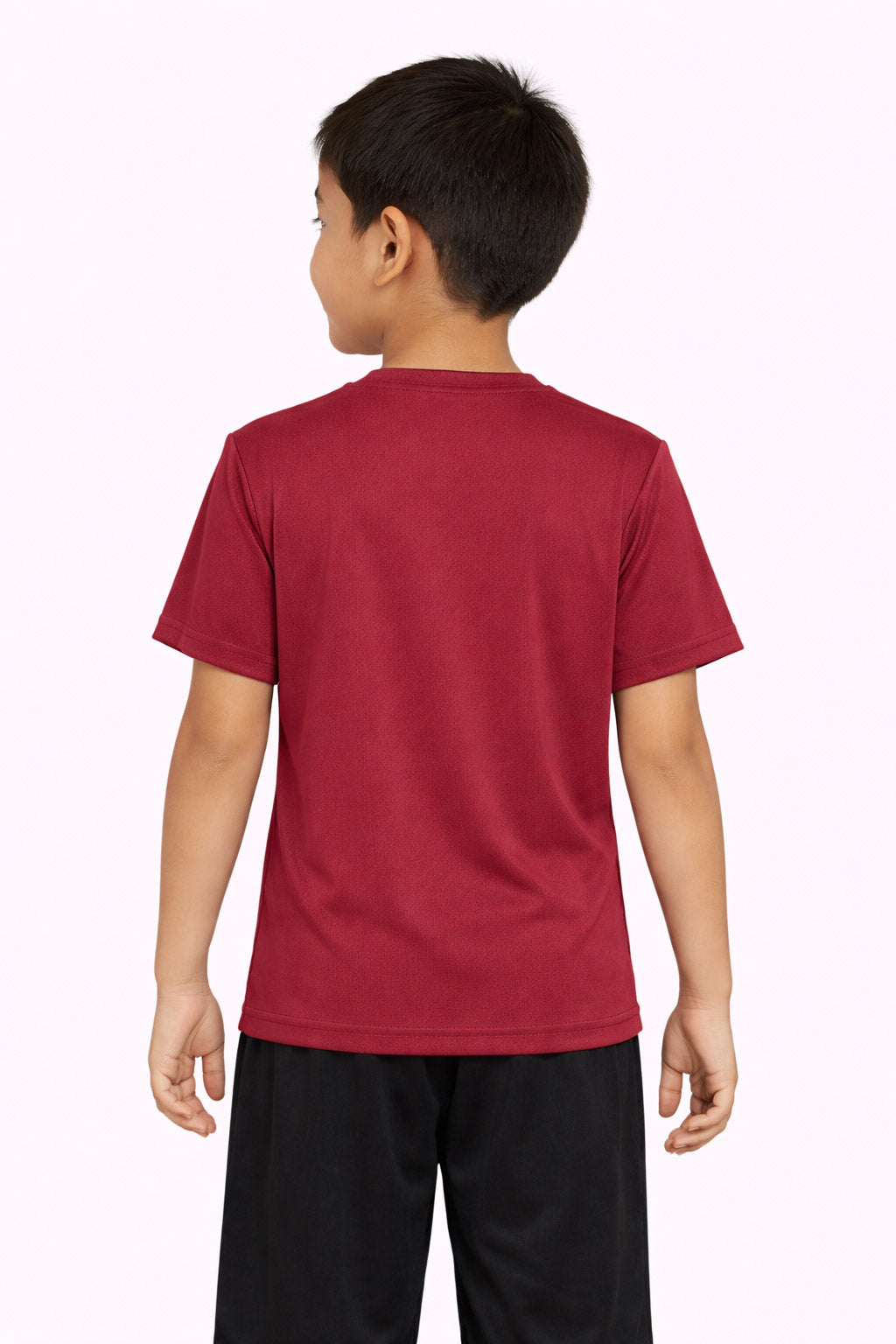 A youth model wearing the Oxymesh™ Crewneck Tech Tee in the color cardinal, made out of 100% polyester, showing the relaxed fit from a back view. This shirt wicks sweat, quick-dries, and eliminates odors for up to 30 UV protection. Made in the USA. #cardinal