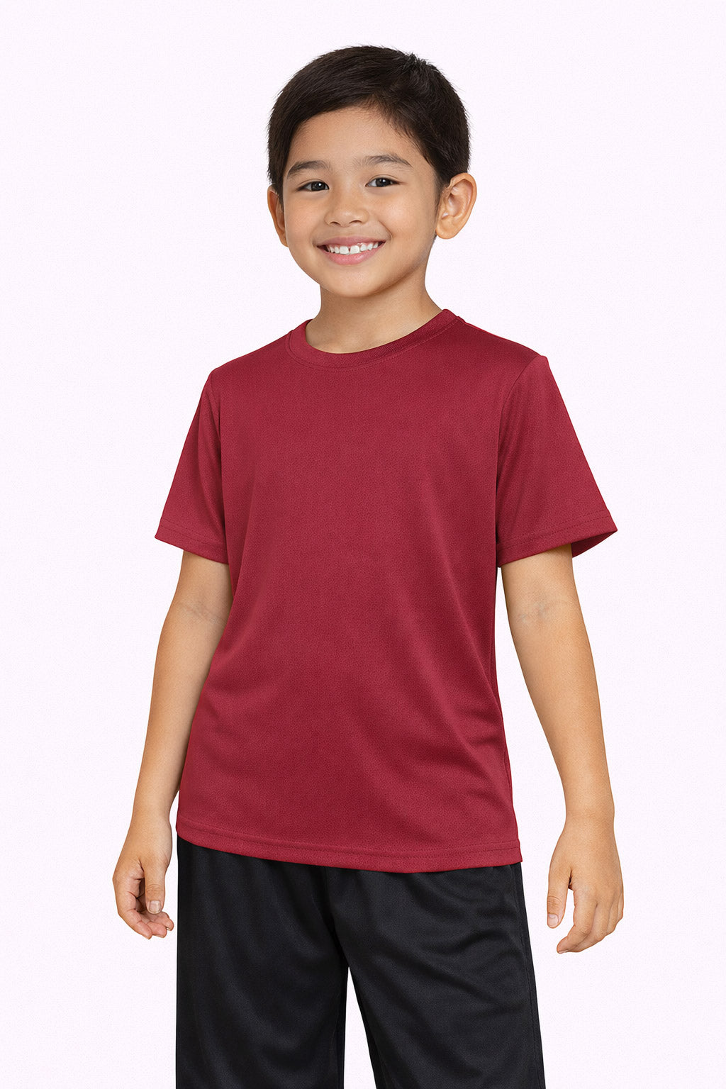 A youth model wearing the Oxymesh™ Crewneck Tech Tee in the color cardinal, made out of 100% polyester, showing the relaxed fit from a front view. This shirt wicks sweat, quick-dries, and eliminates odors for up to 30 UV protection. Made in the USA. #cardinal