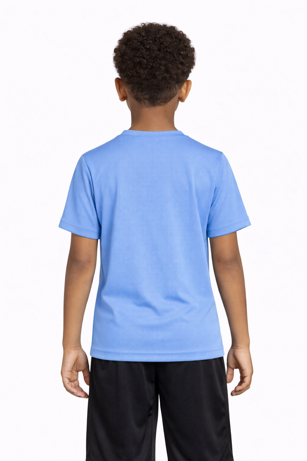 A youth model wearing the Oxymesh™ Crewneck Tech Tee in the color carolina blue, made out of 100% polyester, showing the relaxed fit from a back view. This shirt wicks sweat, quick-dries, and eliminates odors for up to 30 UV protection. Made in the USA. #carolina-blue