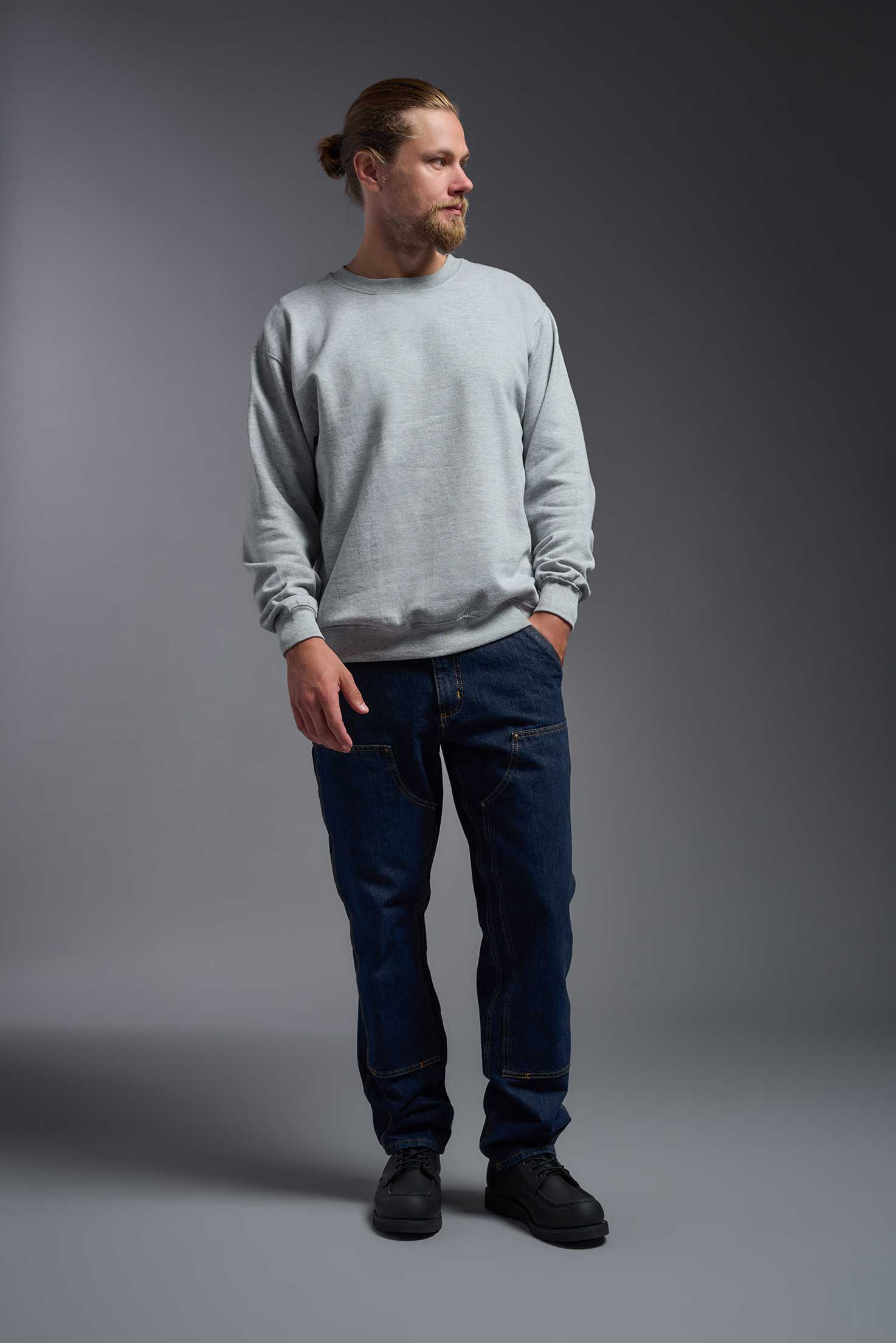 A male model wearing the unisex Americana 3-End Fleece Crewneck Sweatshirt in the color sport gray, made from 75% combed ring-spun USA-grown cotton and 25% polyester, showing the relaxed fit from a front view. This premium fleece hoodie is Made in the USA. #sport-gray