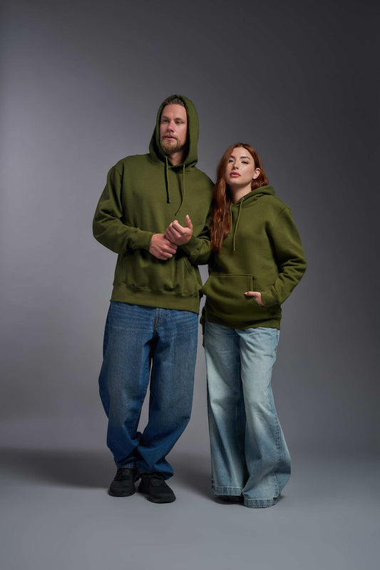 A male and female model wearing the unisex Americana 3-End Fleece Pullover Hoodie in the color military green, made from 75% combed ring-spun USA-grown cotton and 25% polyester, showing the relaxed fit from a front view. This premium fleece hoodie is Made in the USA. #military-green