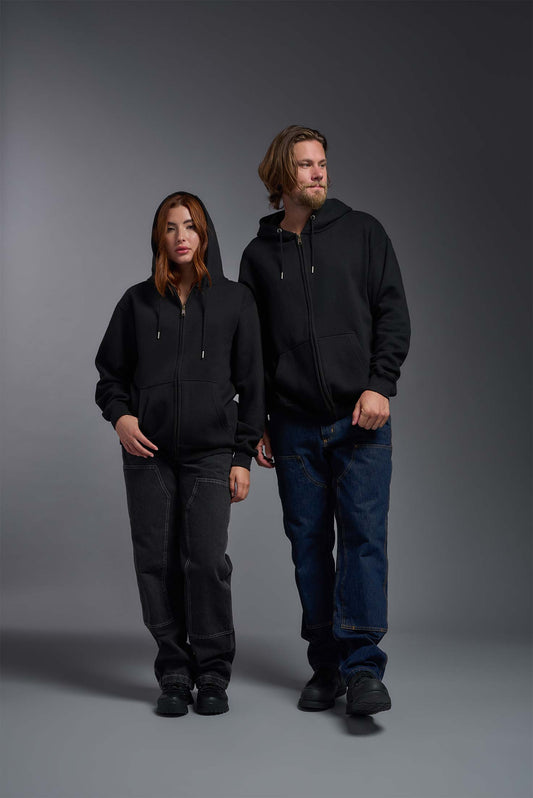 A male and female model wearing the unisex Americana 3-End Fleece Full Zip Hoodie in the color black, made from 75% combed ring-spun USA-grown cotton and 25% polyester, showing the relaxed fit from a front view. This premium fleece hoodie is Made in the USA. #black