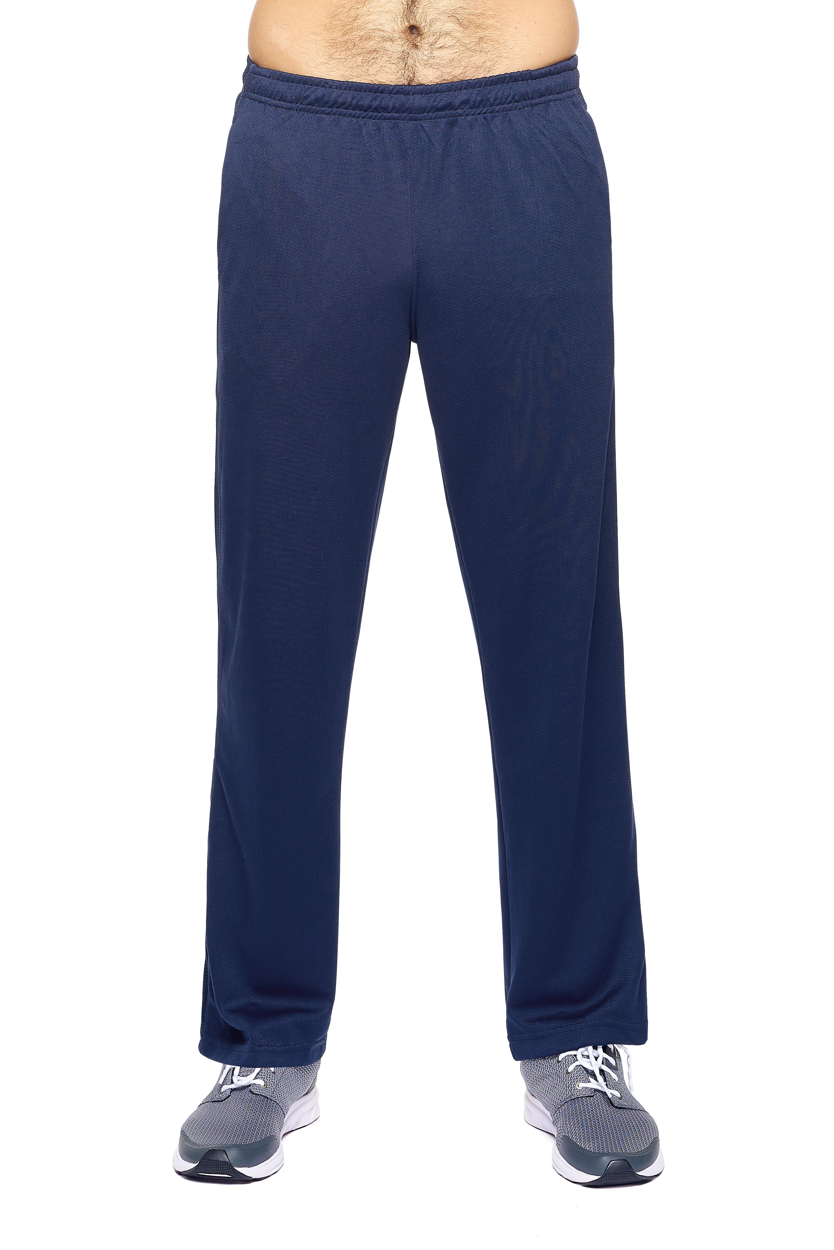 A male model on a white background wearing the men's Sphere City Sport Pants in the color navy made out of 100% polyester showing the relaxed fit from a front view. These pants quick-dry, wick moisture and are made in the USA. #navy