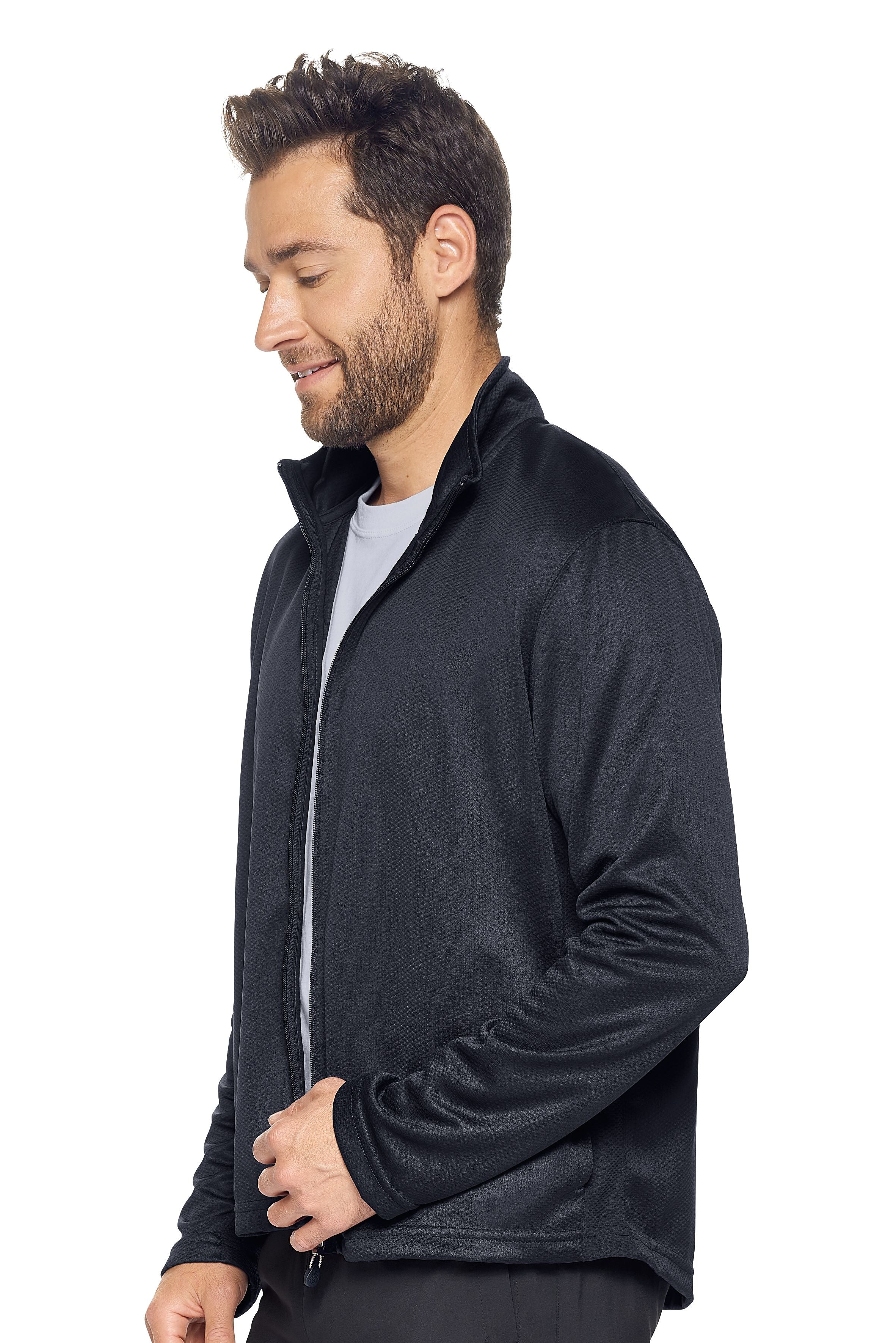 A male model on a white background wearing the men's Sphere Sportsman Jacket in the color black made out of 100% polyester showing the relaxed fit from a side view. This jacket quick-dries, wicks moisture and is made in the USA. #black