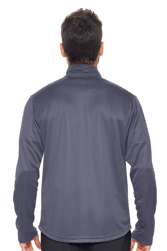 A male model on a white background wearing the men's Sphere Sportsman Jacket in the color charcoal made out of 100% polyester showing the relaxed fit from a back view. This jacket quick-dries, wicks moisture and is made in the USA. #charcoal