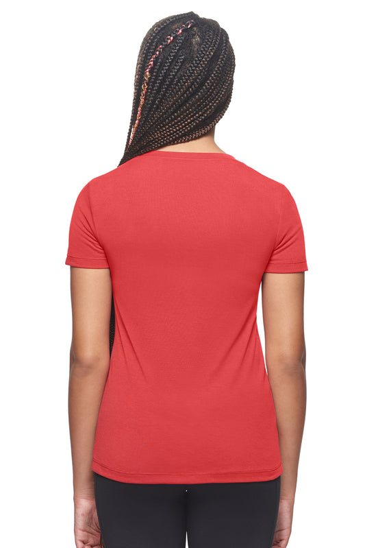 A female model with braids on a white background wearing the women's Siro™ V-Neck Tee in the color scarlet red, made out of 100% snag-free filament polyester, showing the modern fit from a back view. This women's v-neck shirt is breathable, quick-drying, moisture-wicking, and made in the USA. Available in bulk for wholesale purchase. #scarlet