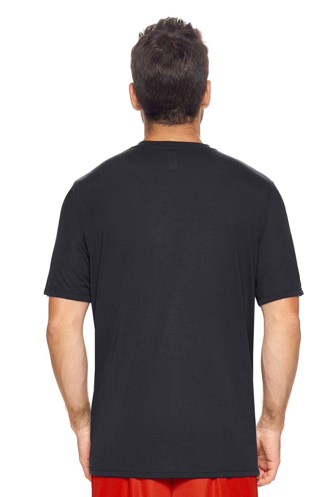 A male model with brown hair wearing the men's Siro™ Crewneck Tee in the color black, made from 100% filament polyester technology, showing the modern fit from a back view. This shirt is elevated and fashion forward while also offering quick-drying and moisture-wicking performance. It is made in the USA, and available for bulk purchase. #black
