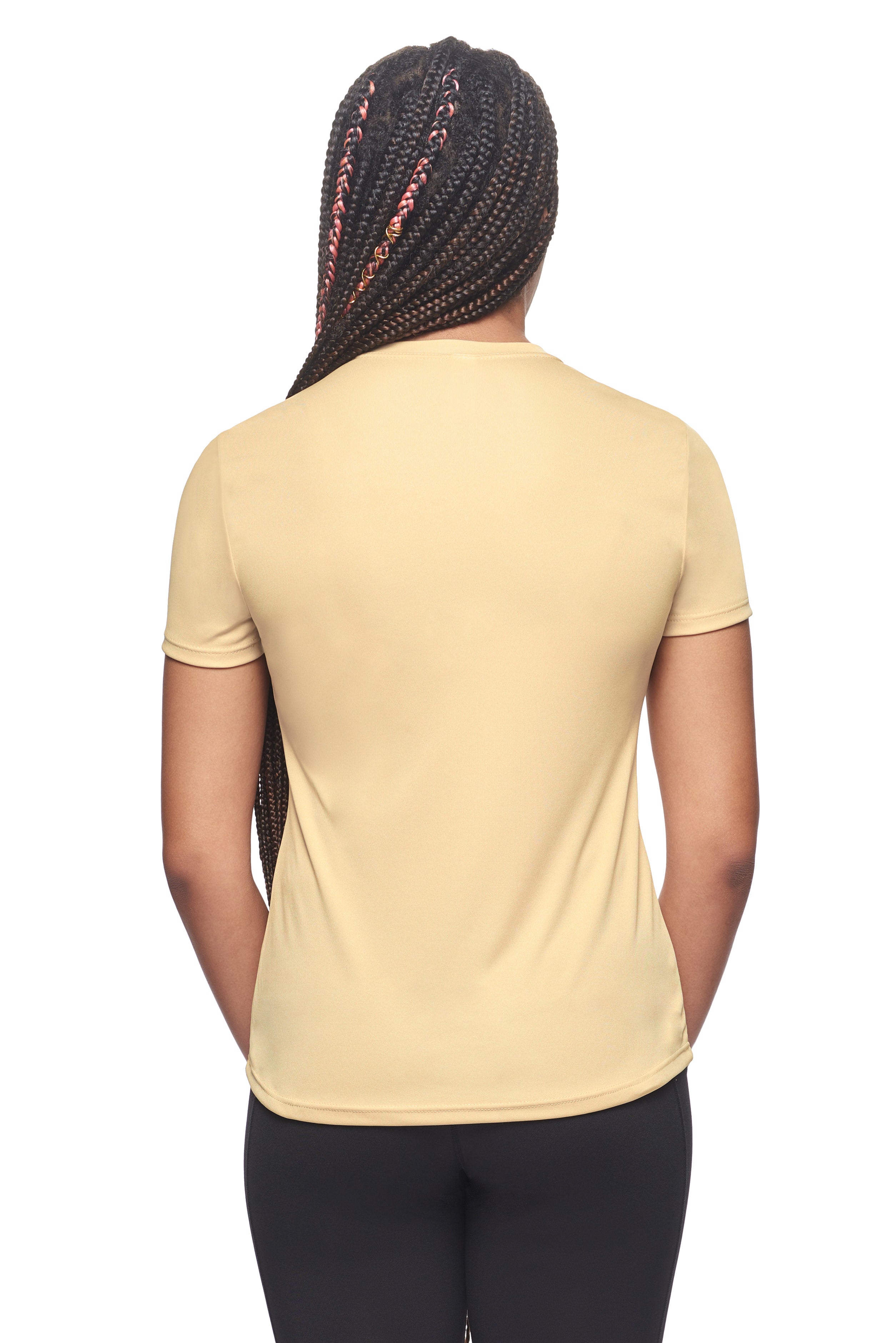 A female model wearing the women's DriMax Crewneck Expert Tee in the color vegas gold, made out of 100% polyester, showing the relaxed fit from a backr view. This shirt is quick-drying, moisture-wicking, offers up to 30 upf protection and is made in the USA. #vegas-gold