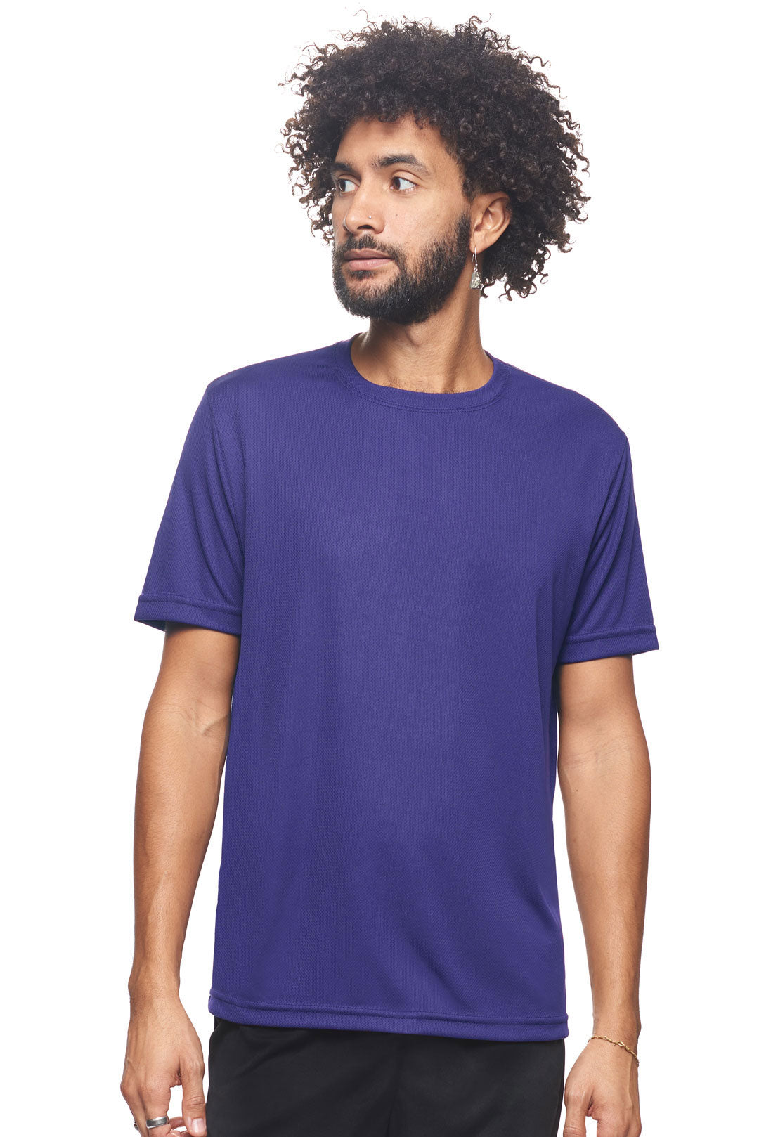A male model wearing the men's Oxymesh Crewneck Tech Tee in the color purple, made out of 100% polyester, showing the relaxed fit from a front view. This shirt is breathable, wicks away moisture, quick-dries, and is made in the USA. #purple
